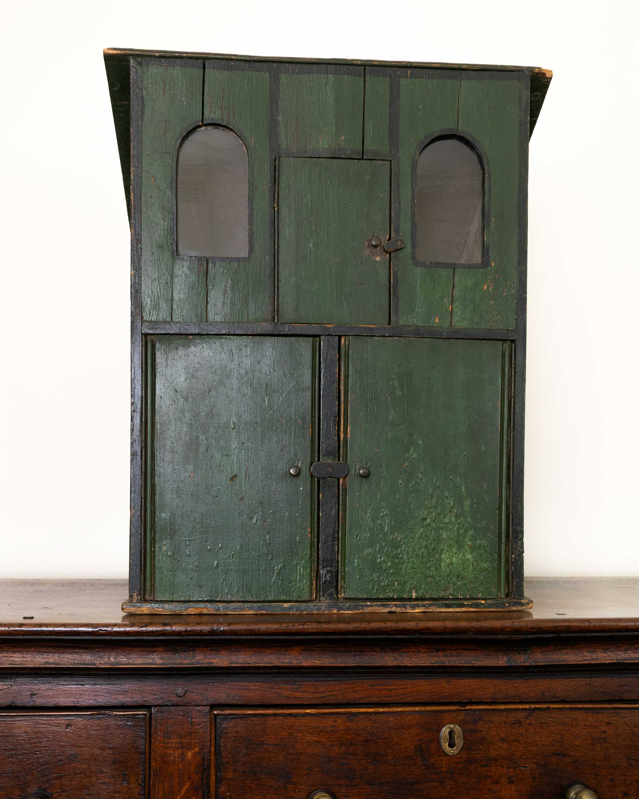 Vintage green wooden cabinet with metal doors on a white background