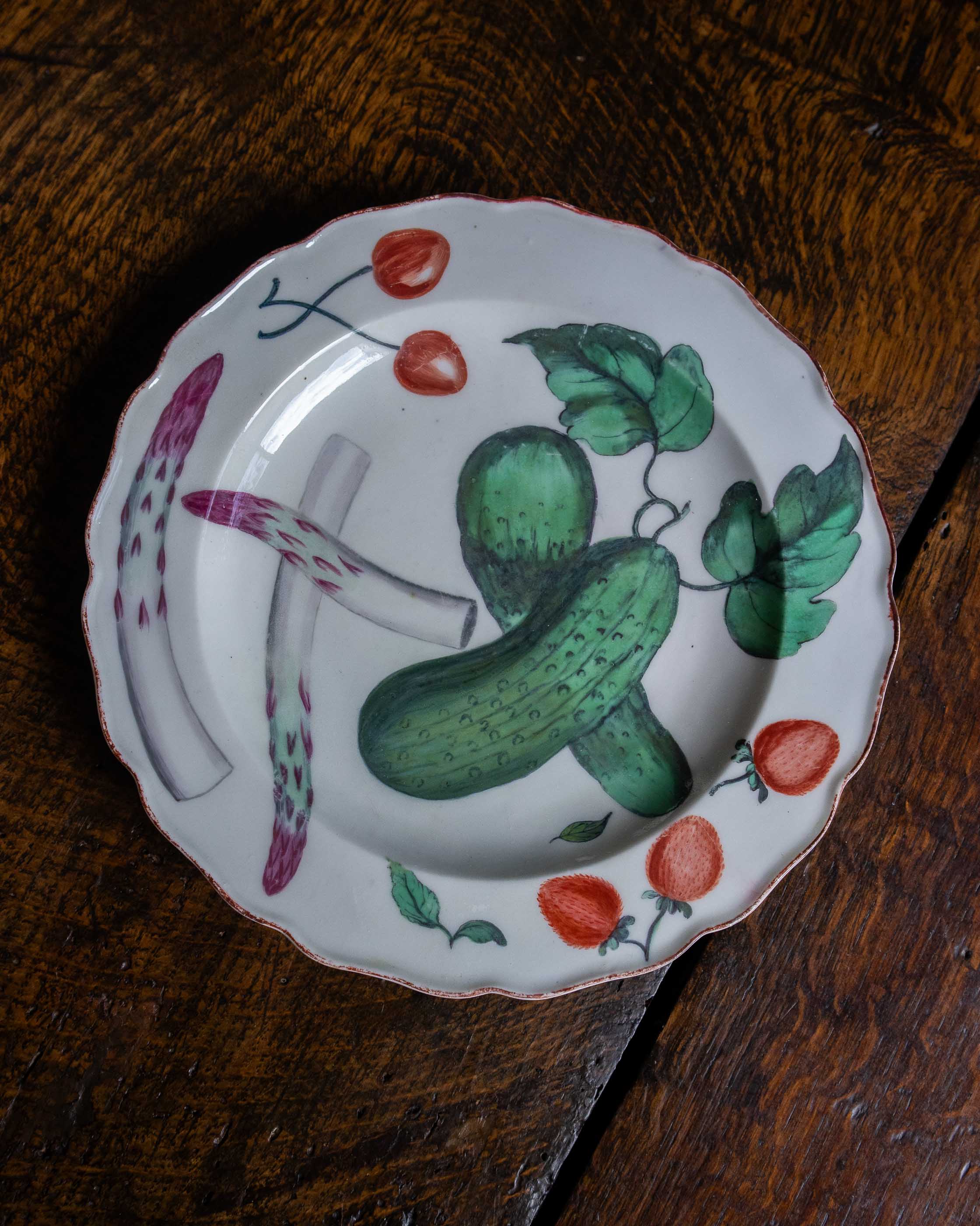 Decorative plate with hand-painted vegetables on a wooden surface