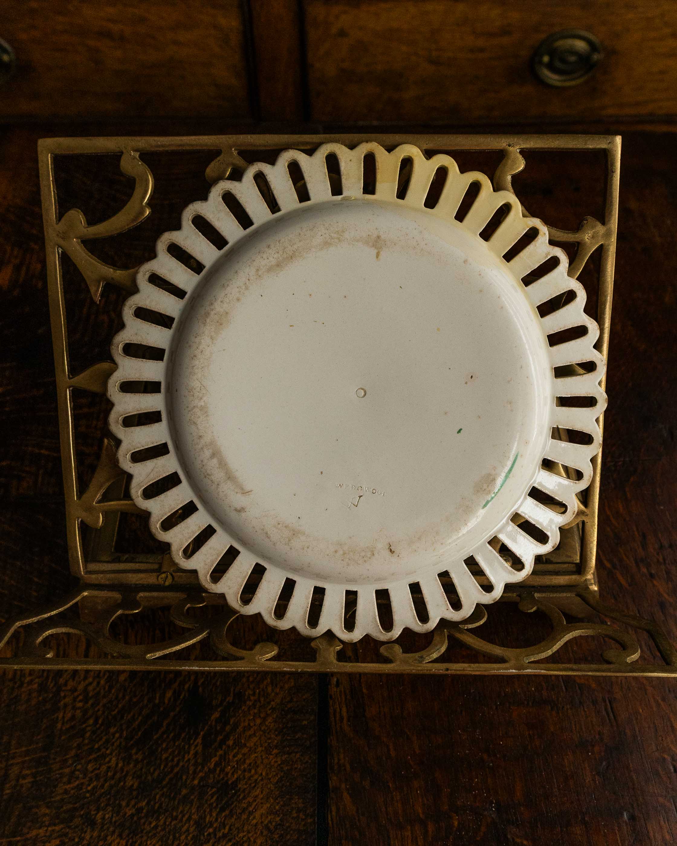 White ceramic plate with decorative gold frame on a wooden surface
