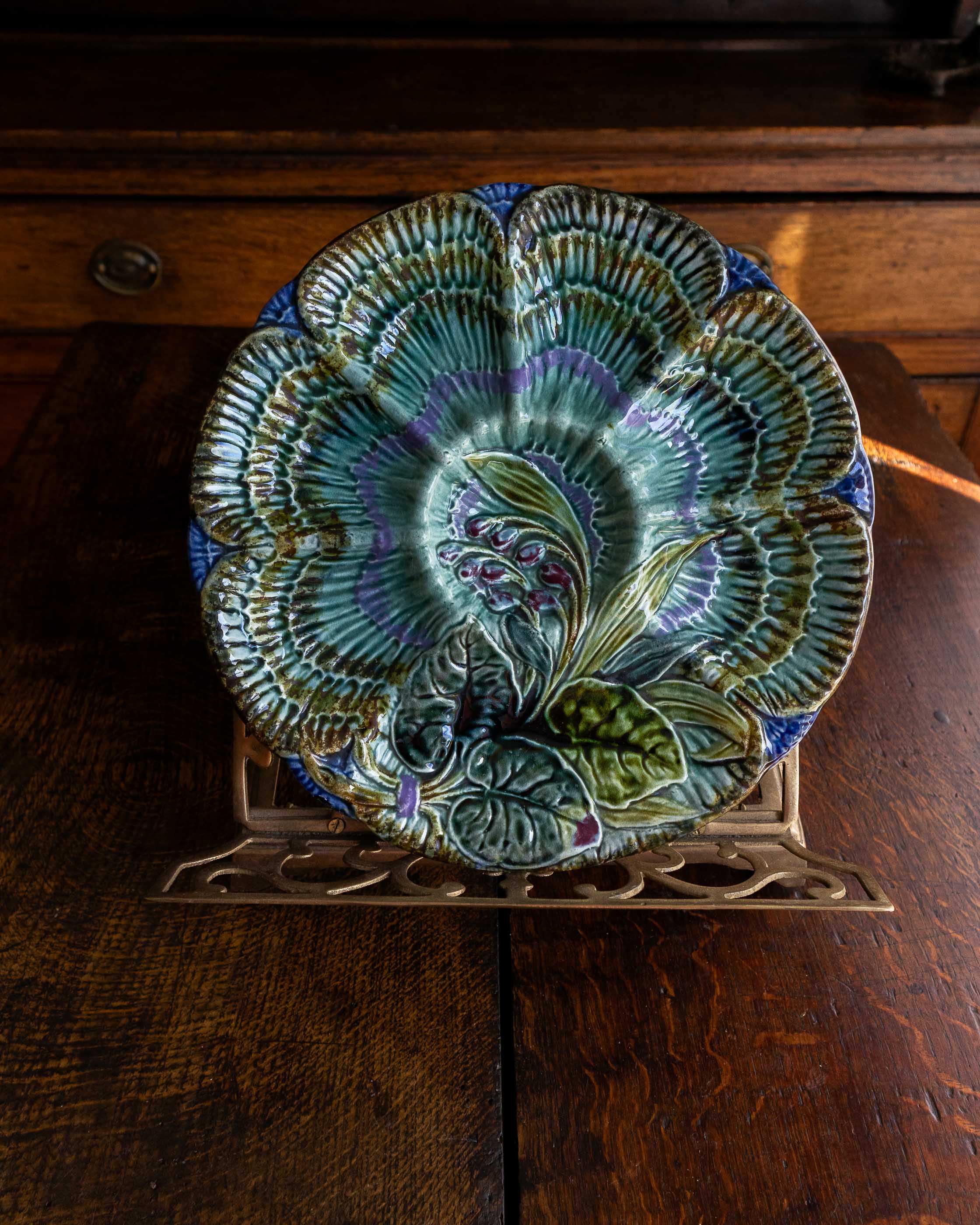 Decorative ceramic plate with floral design on a wooden surface