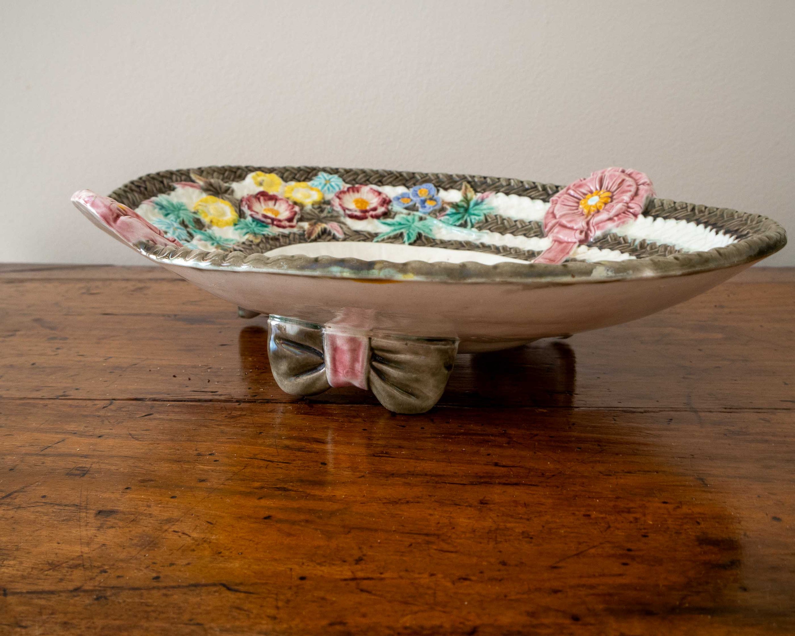 Decorative ceramic dish with floral designs on a wooden surface