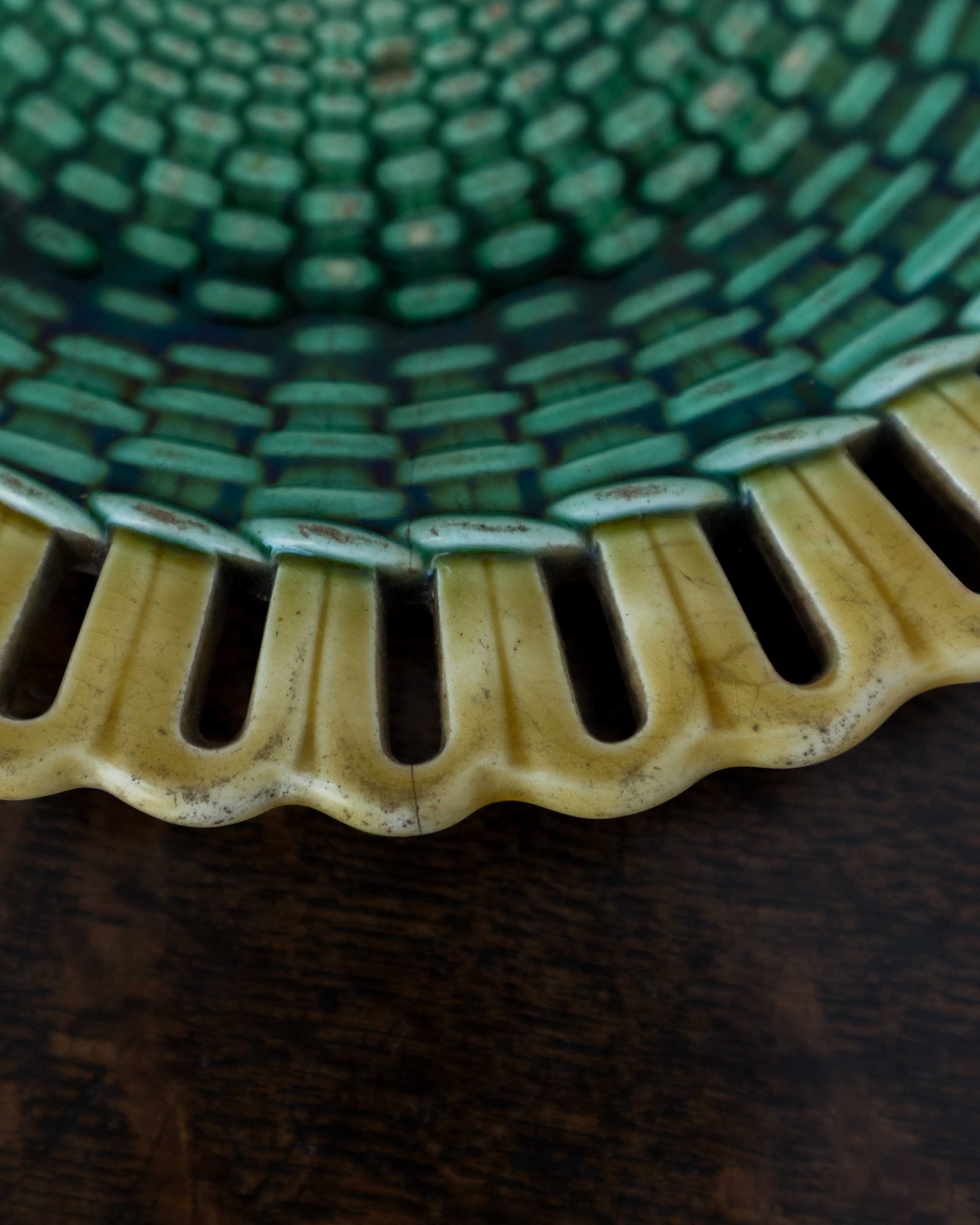 Close-up of a textured green and yellow ceramic dish