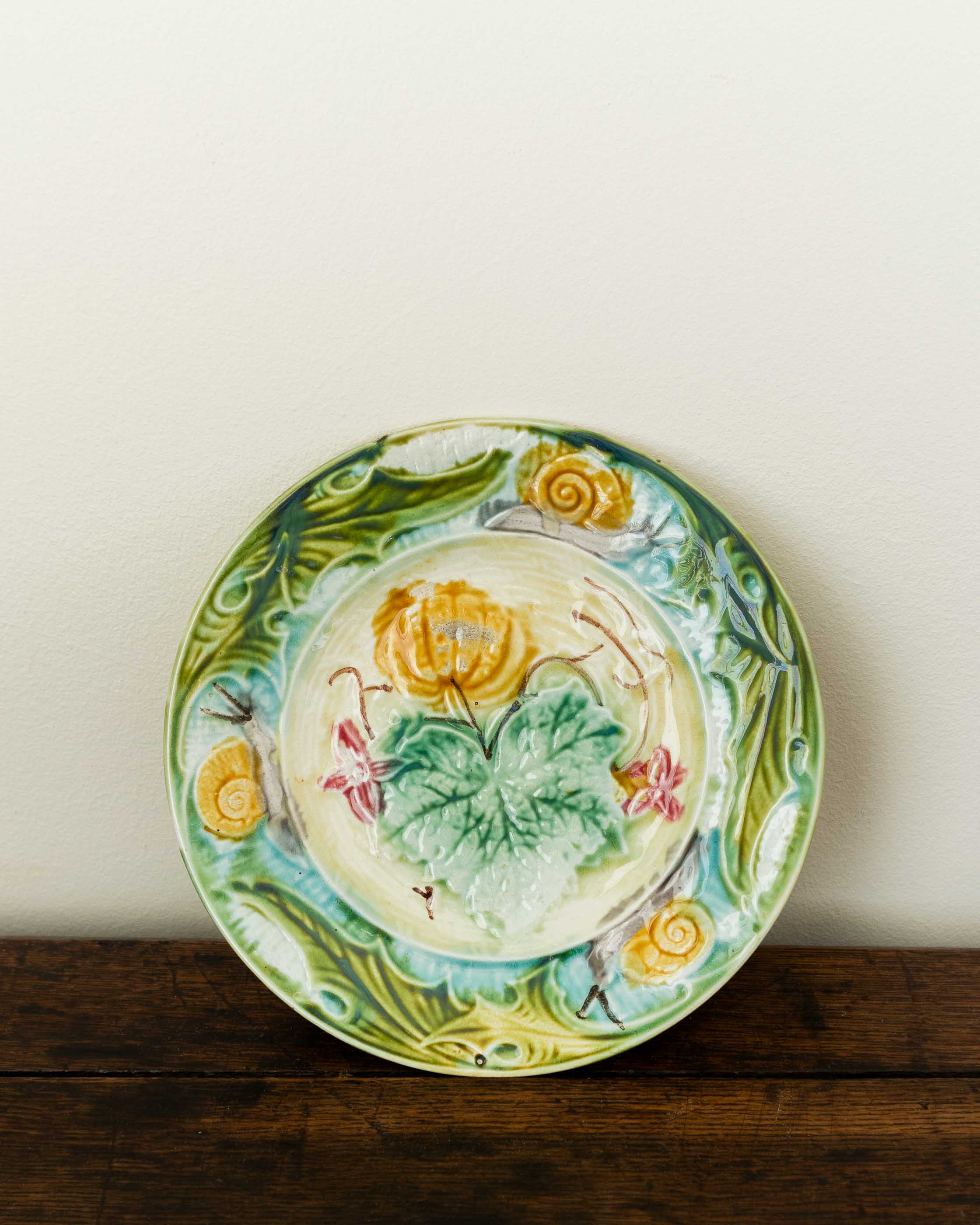 Decorative ceramic plate with floral design on a wooden surface