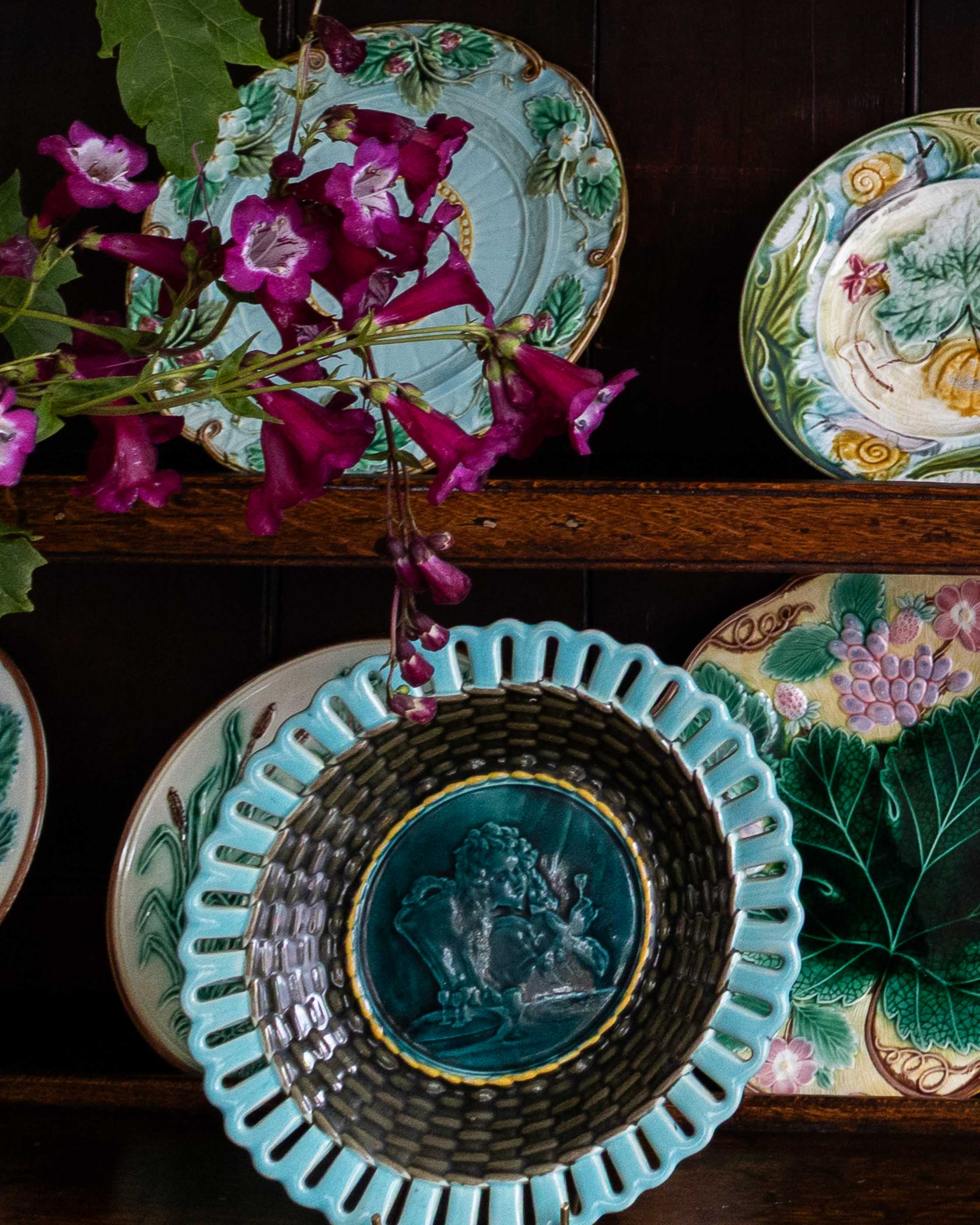 Decorative plates with floral patterns and a central relief design on a dark background.