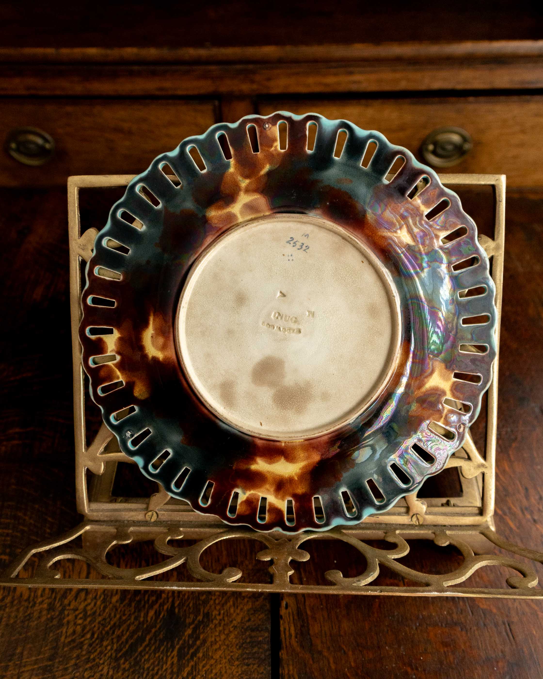 Decorative plate with a tortoiseshell pattern on a wooden surface