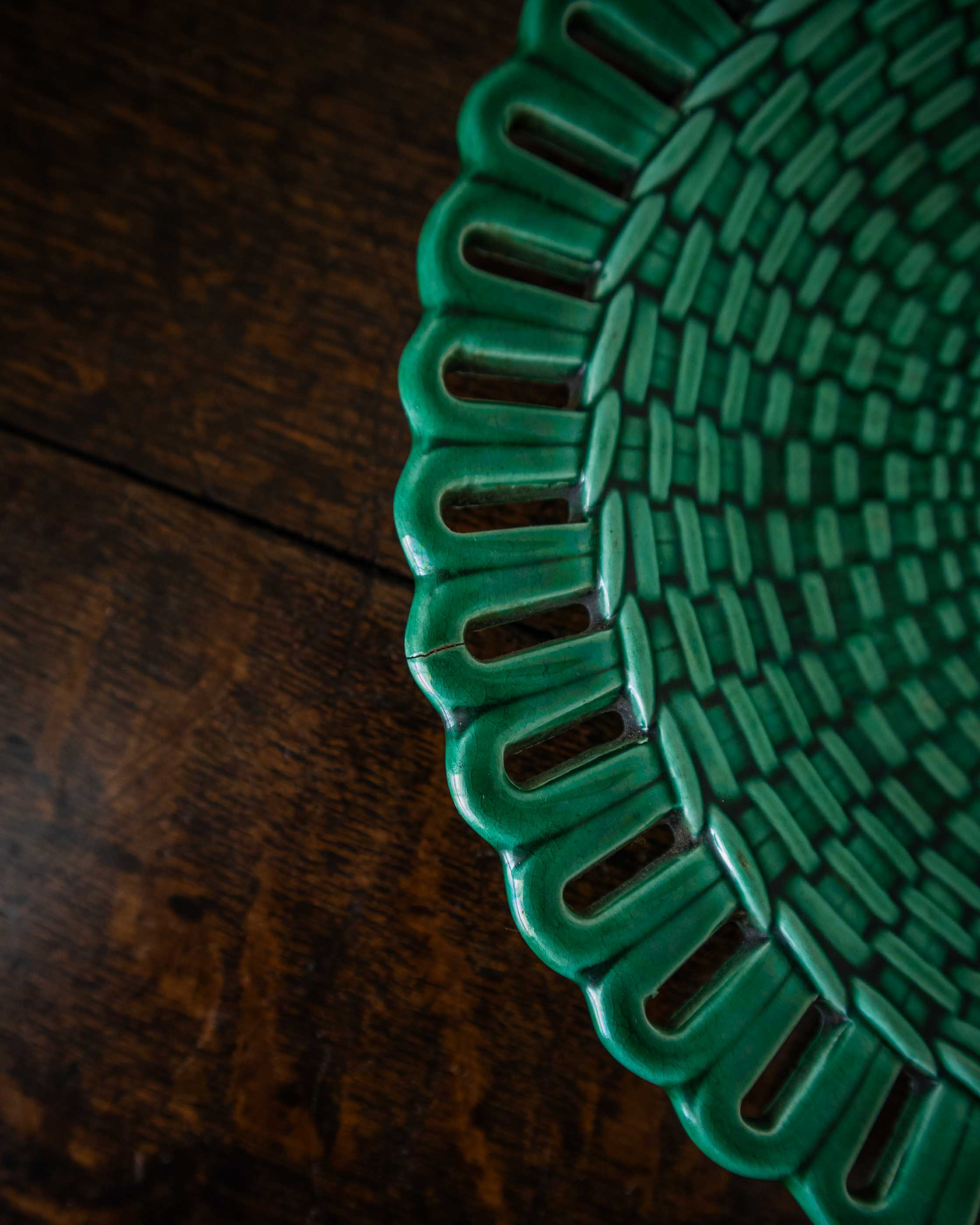 Close-up of a green woven mat on a wooden surface