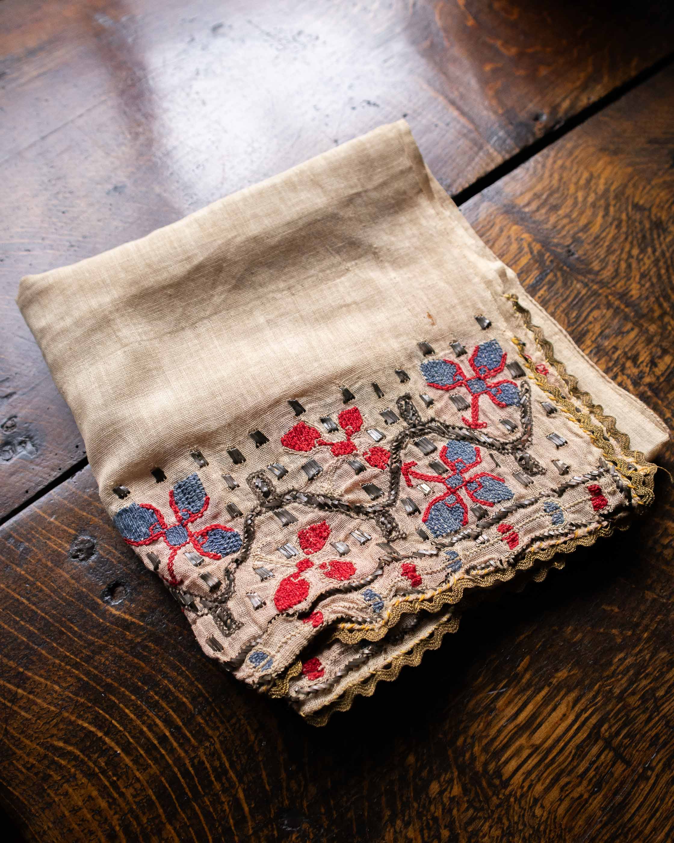 Embroidered fabric with floral patterns on a wooden surface