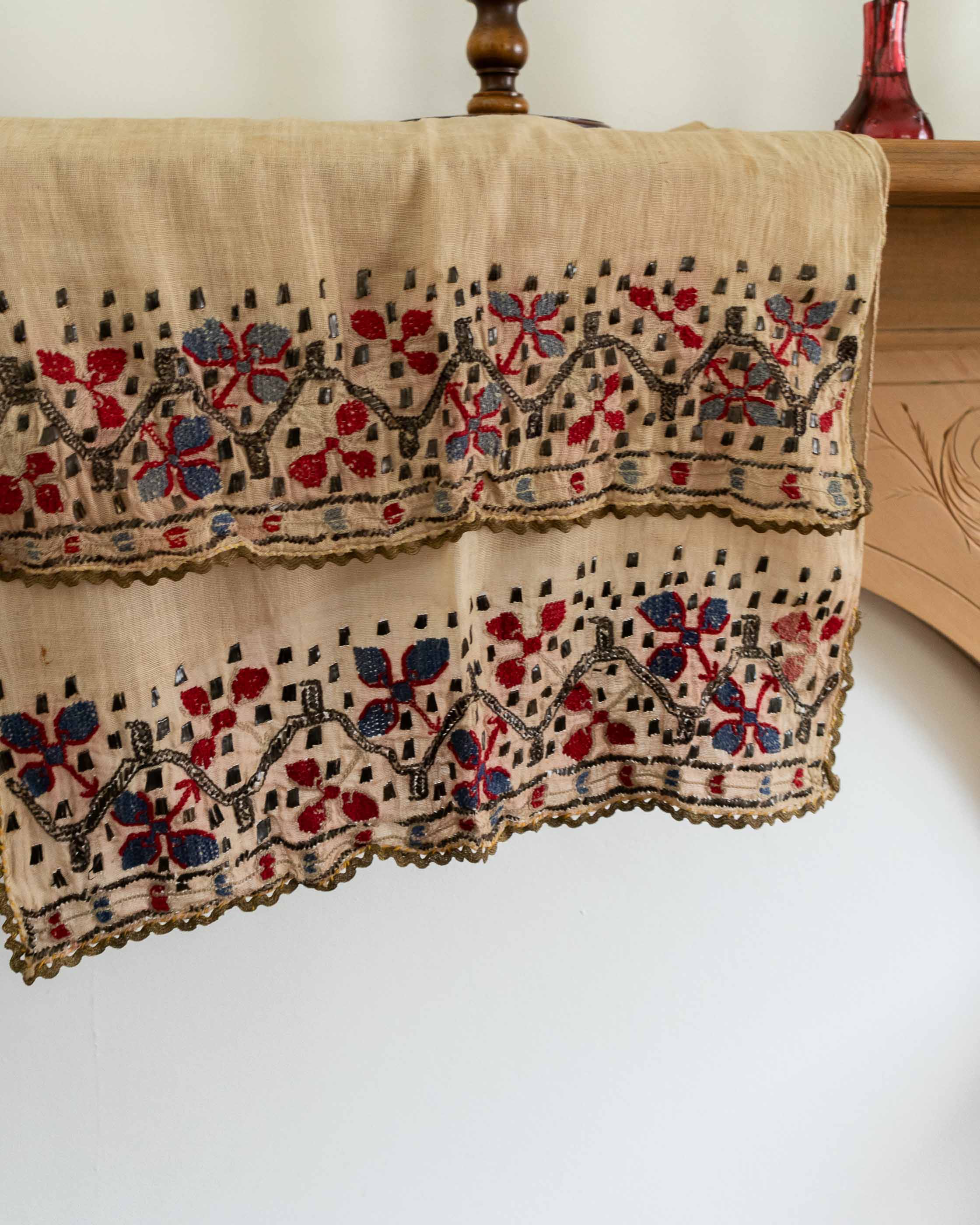 Textile with intricate embroidery on a wooden surface