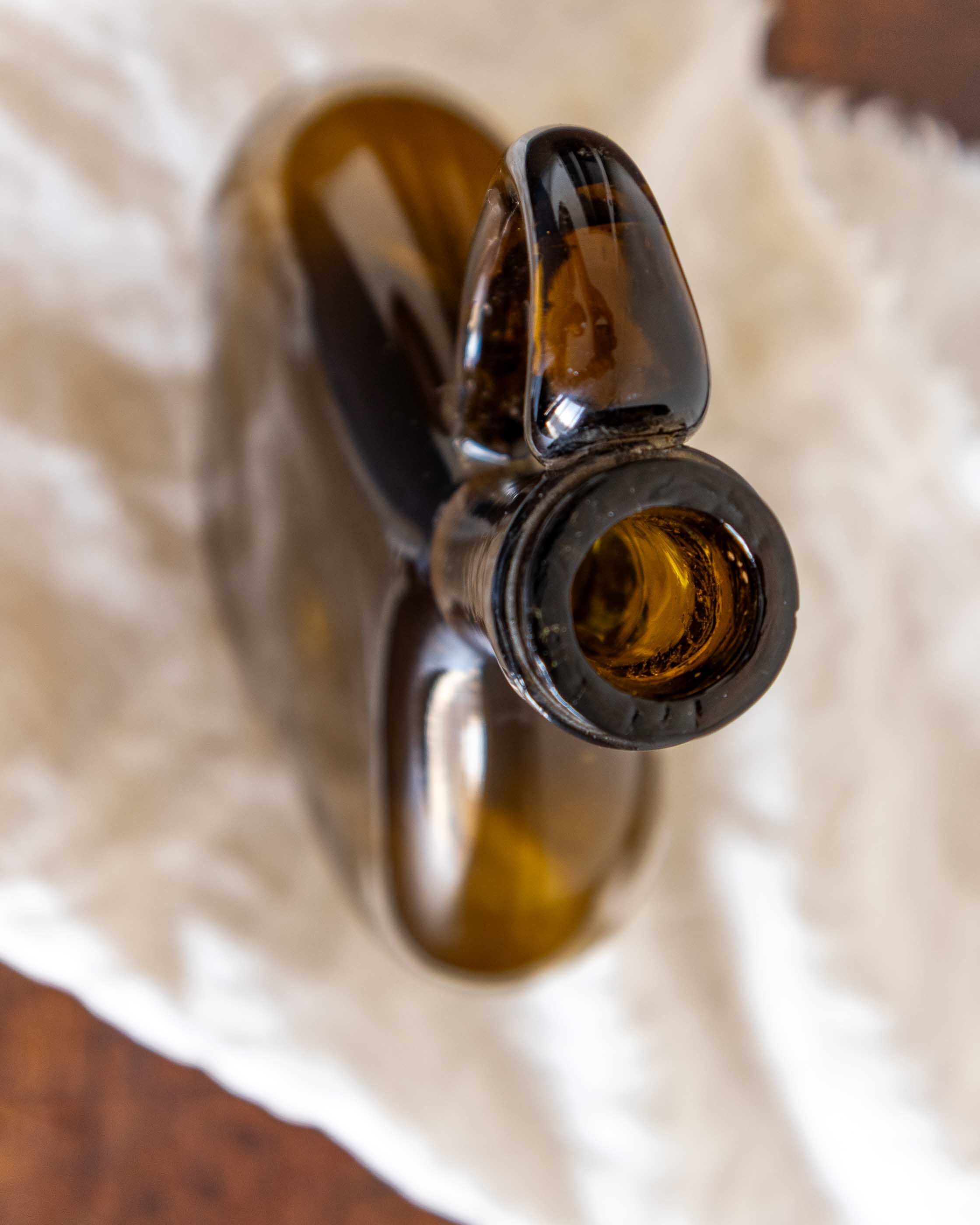 Brown glass bottle on a white cloth surface