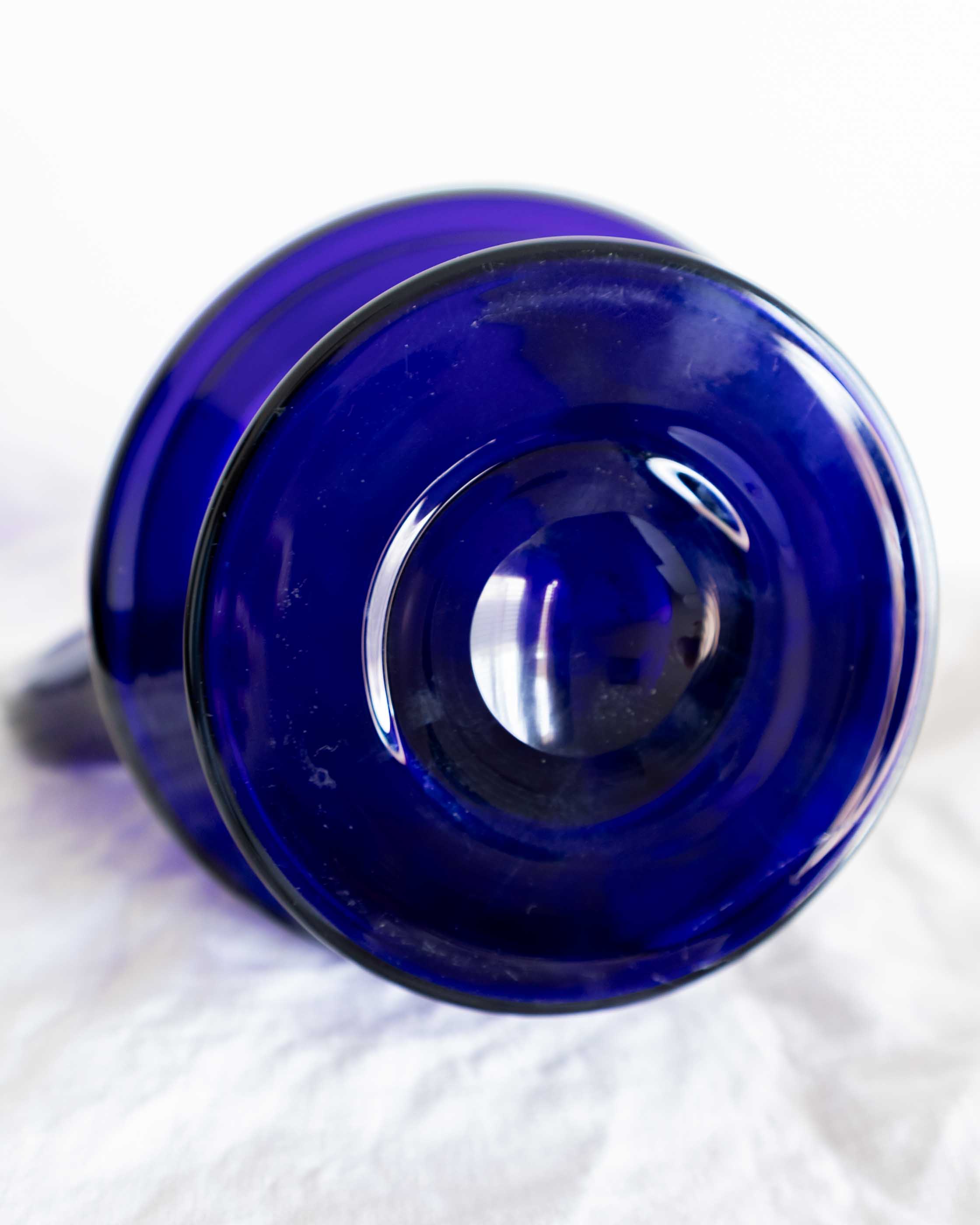 Blue glass jug on a white background