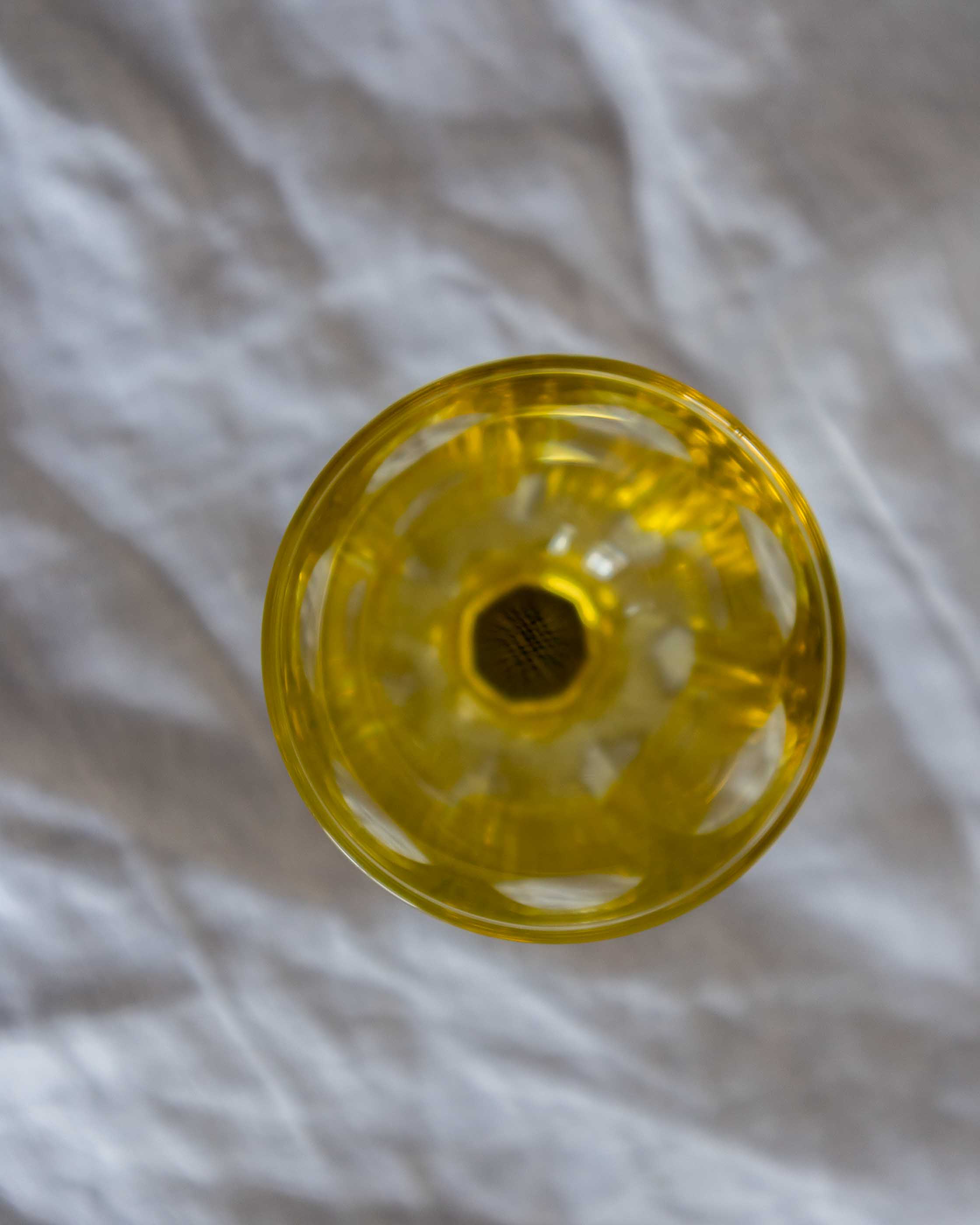 Yellow glass on a textured grey background