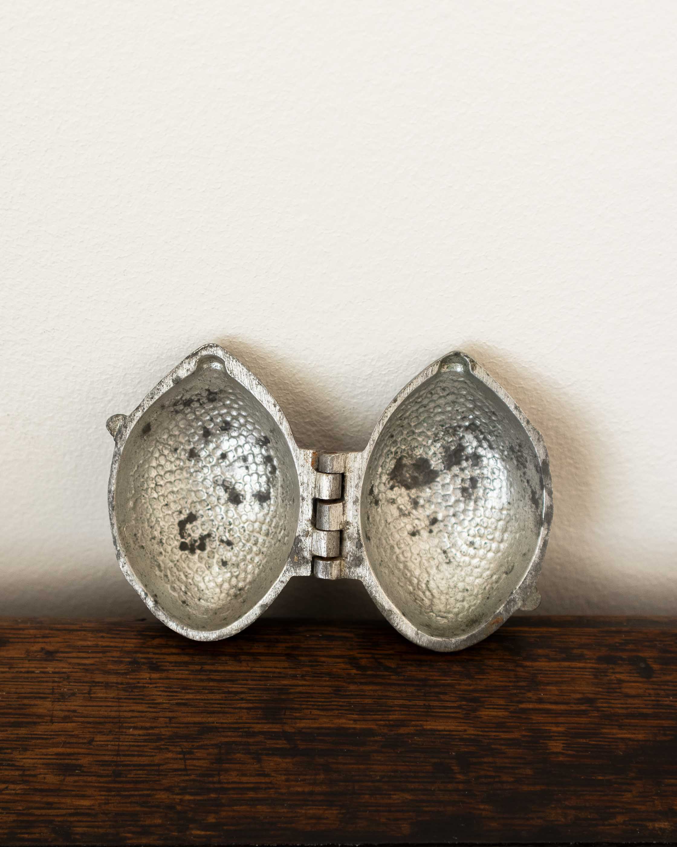 Lemon pewter ice cream mould on wooden surface