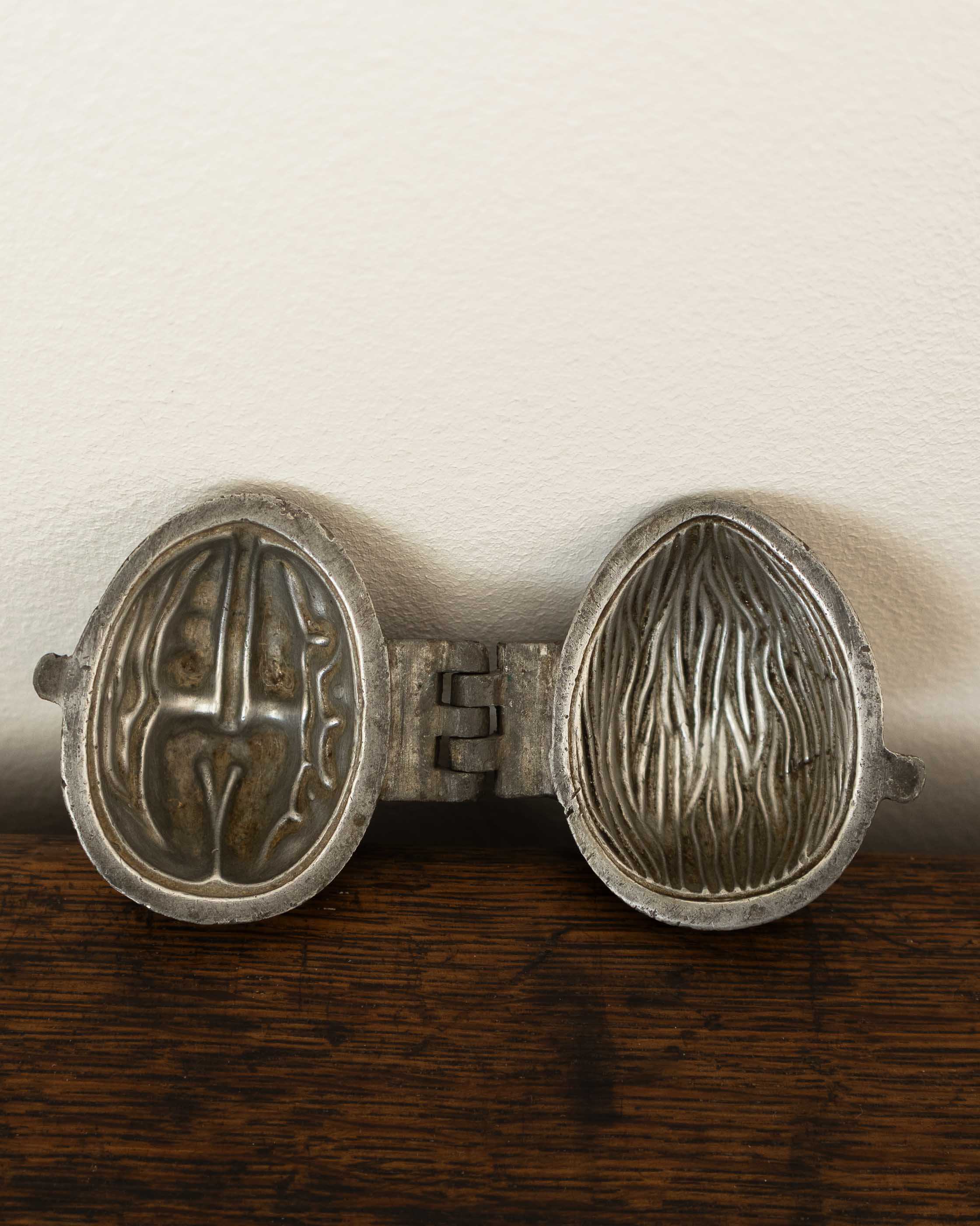 Walnut pewter ice cream mould on wooden surface