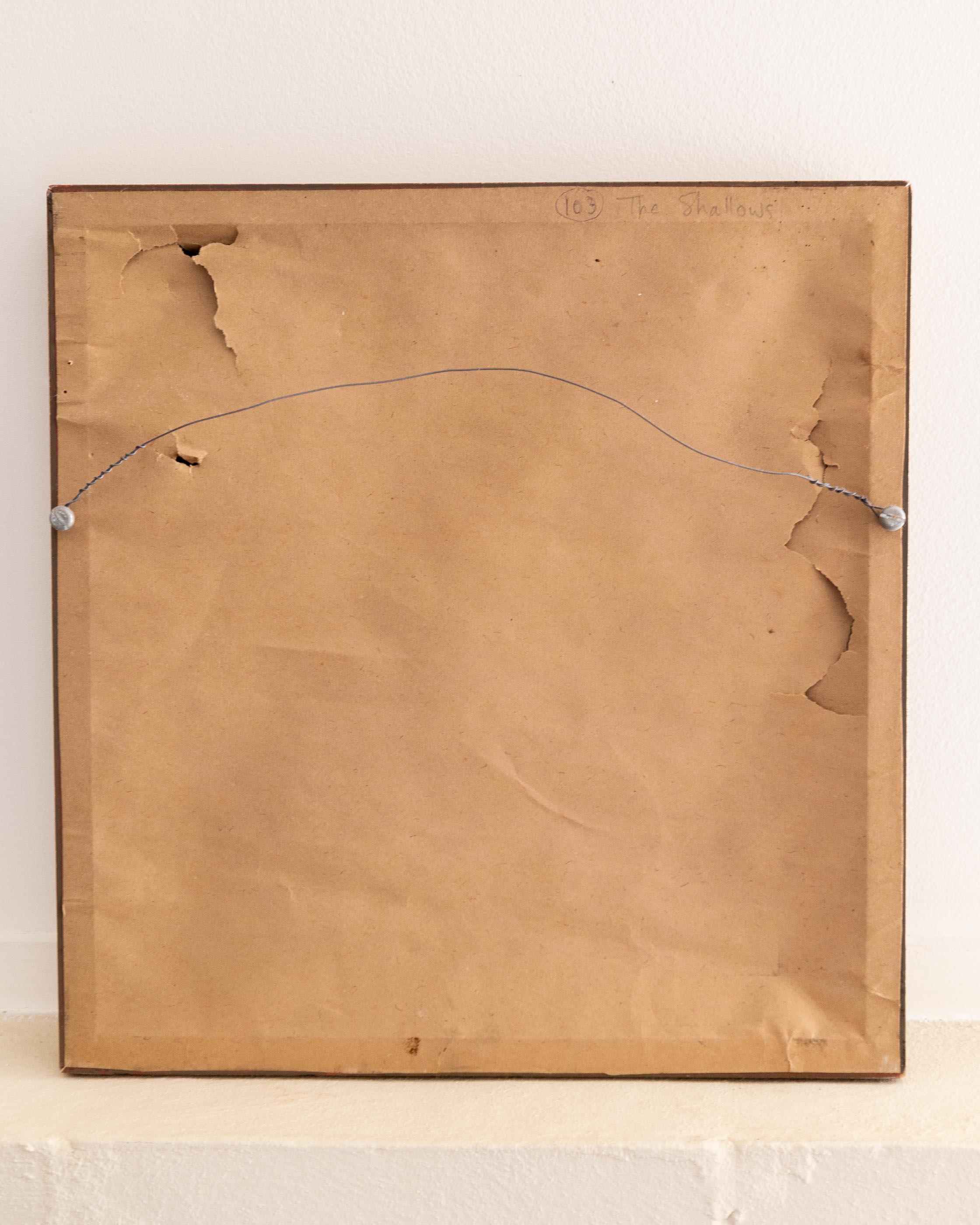 Back of a painting with signature and date on a beige background