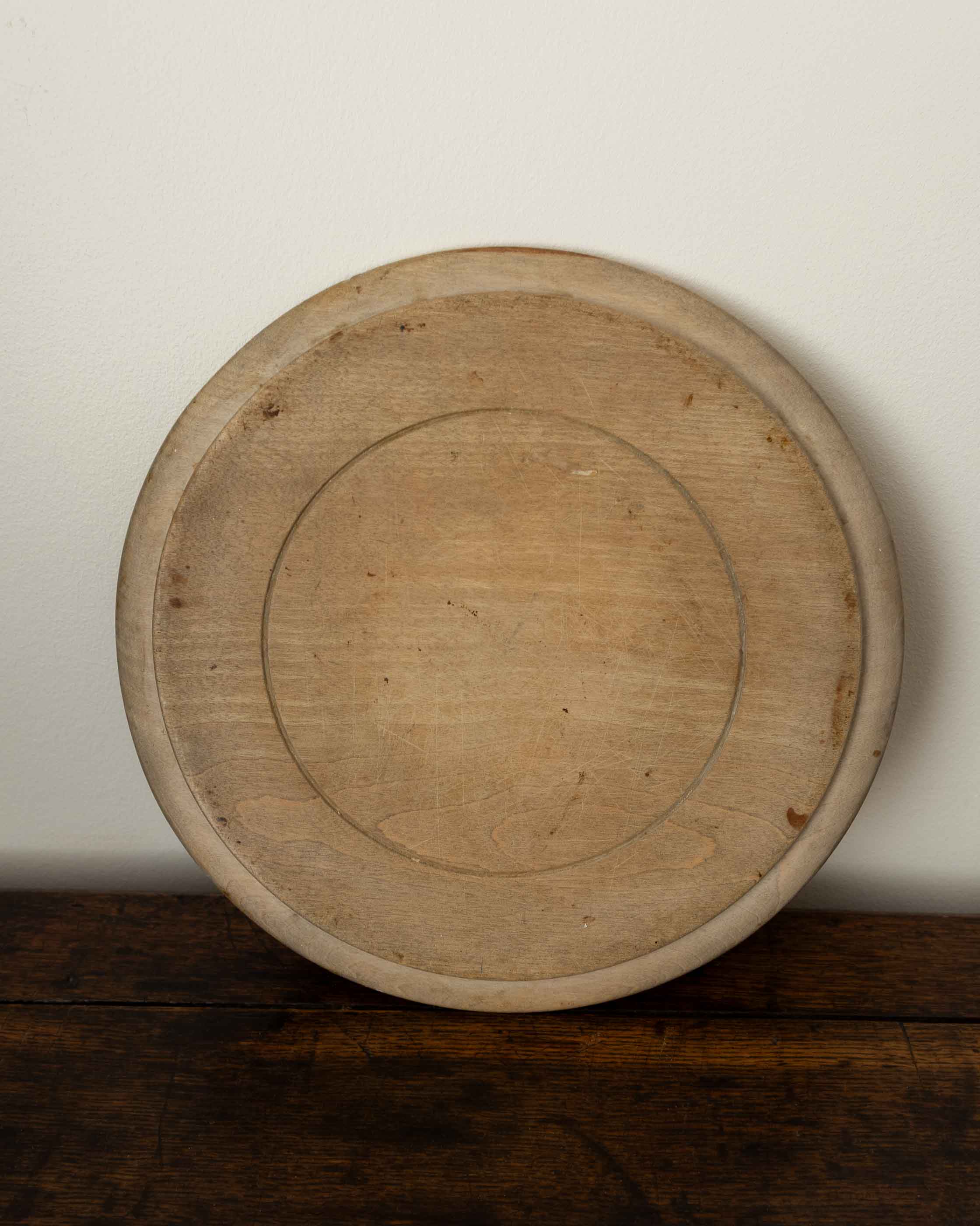 Wooden breadboard on a wooden surface with a white background