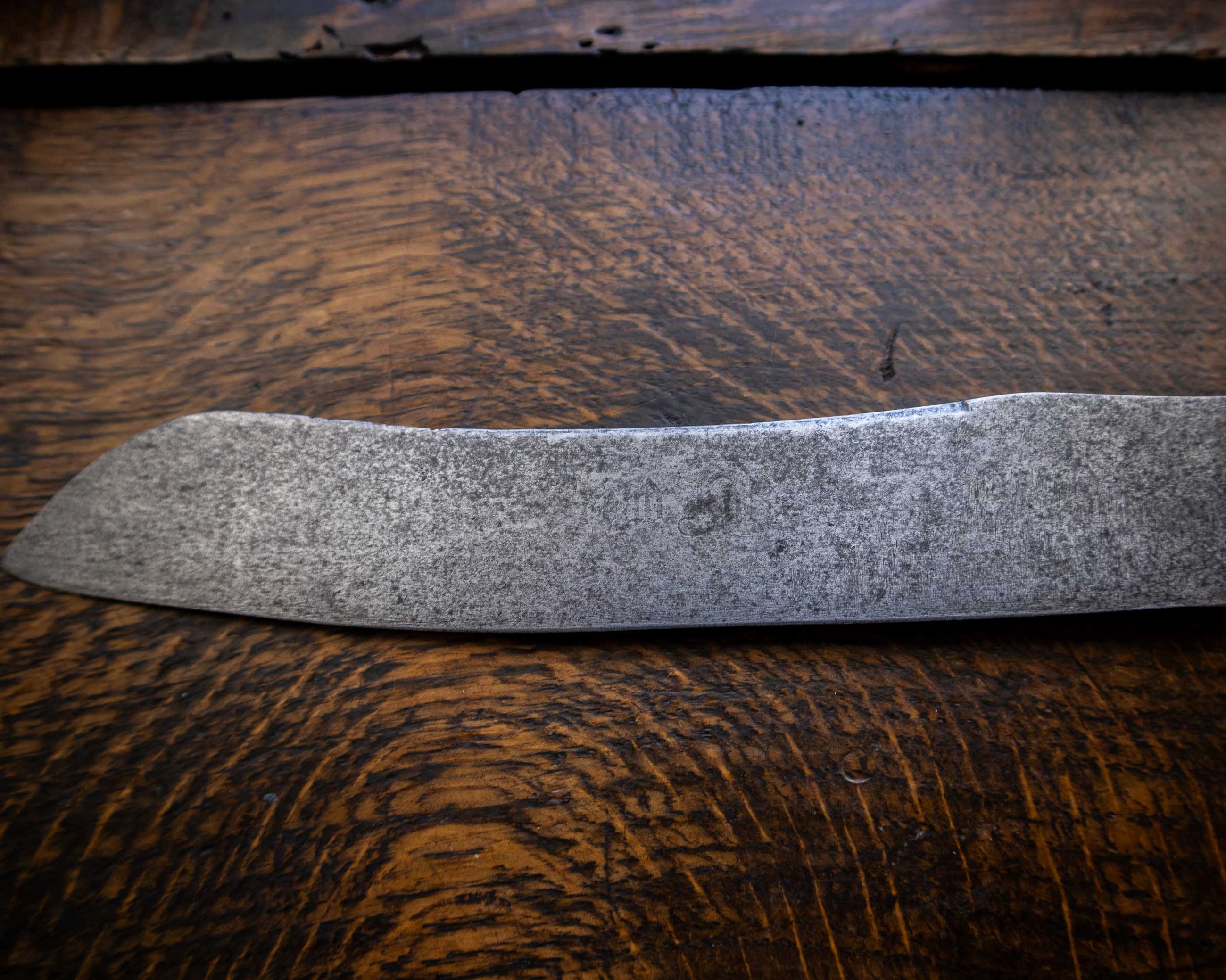 Bread knife blade on a wooden surface