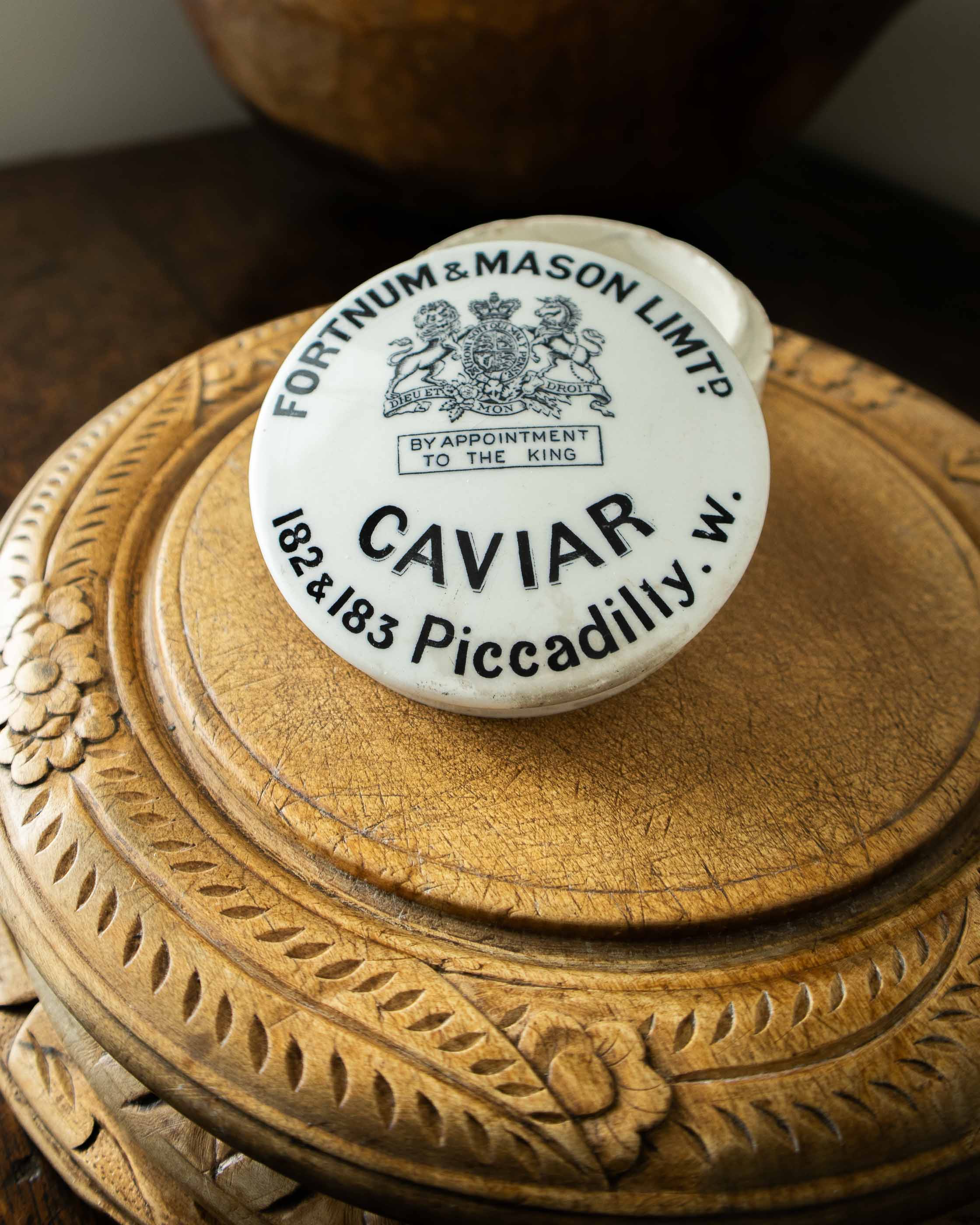 Caviar container with Fortnum & Mason label on a wooden surface