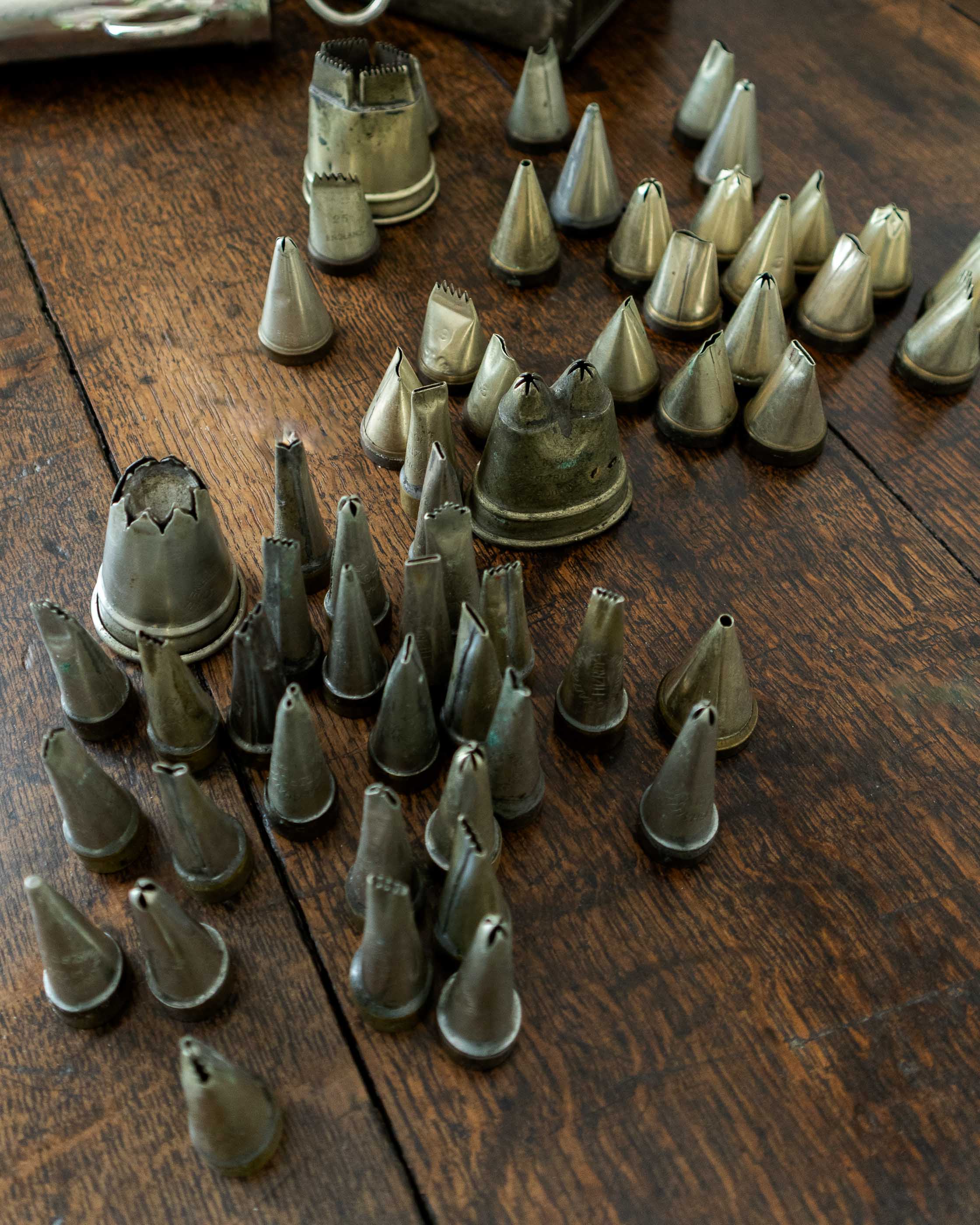 Collection of metal baking tips on a wooden surface