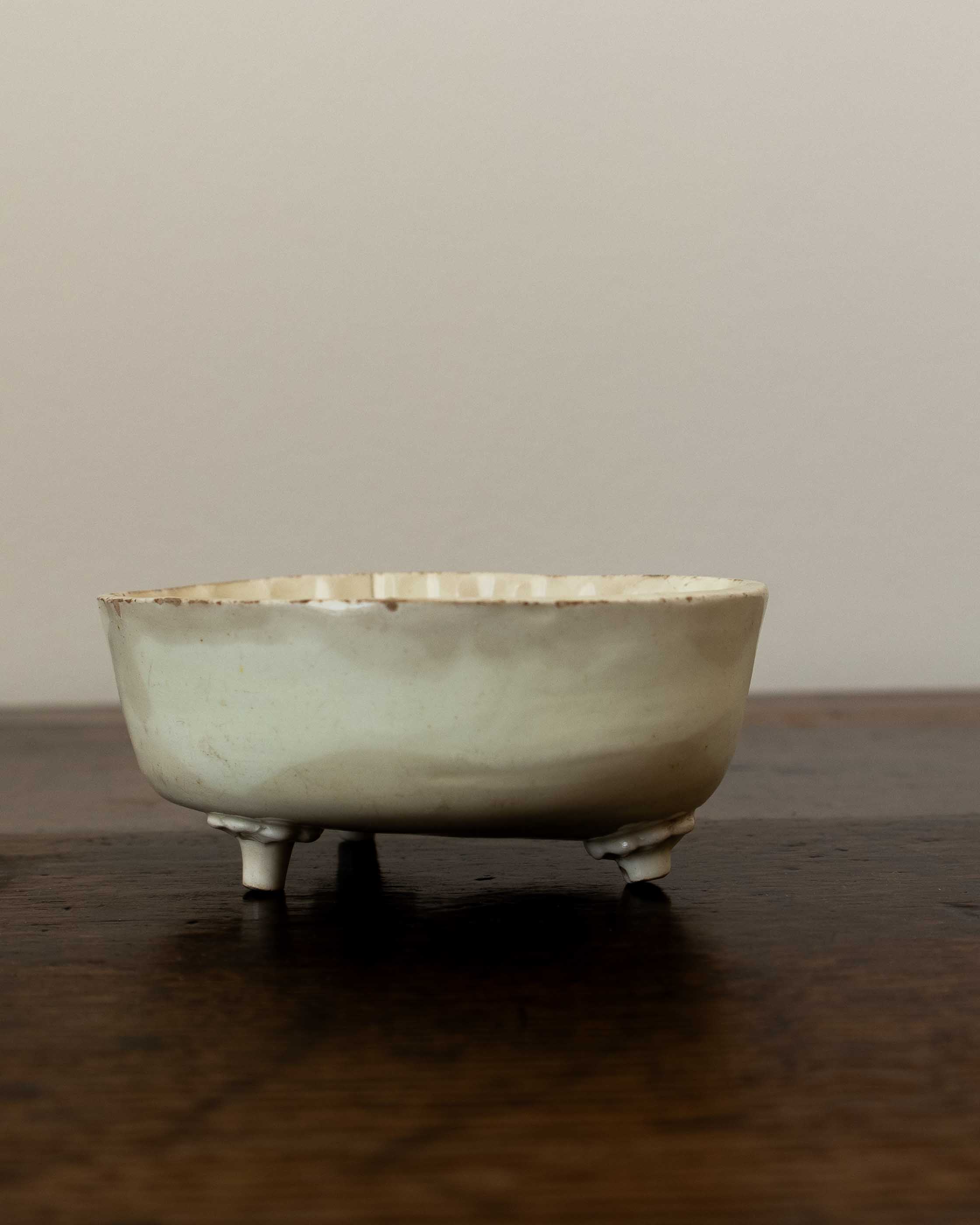 Vintage ceramic mould on a wooden surface with a plain background