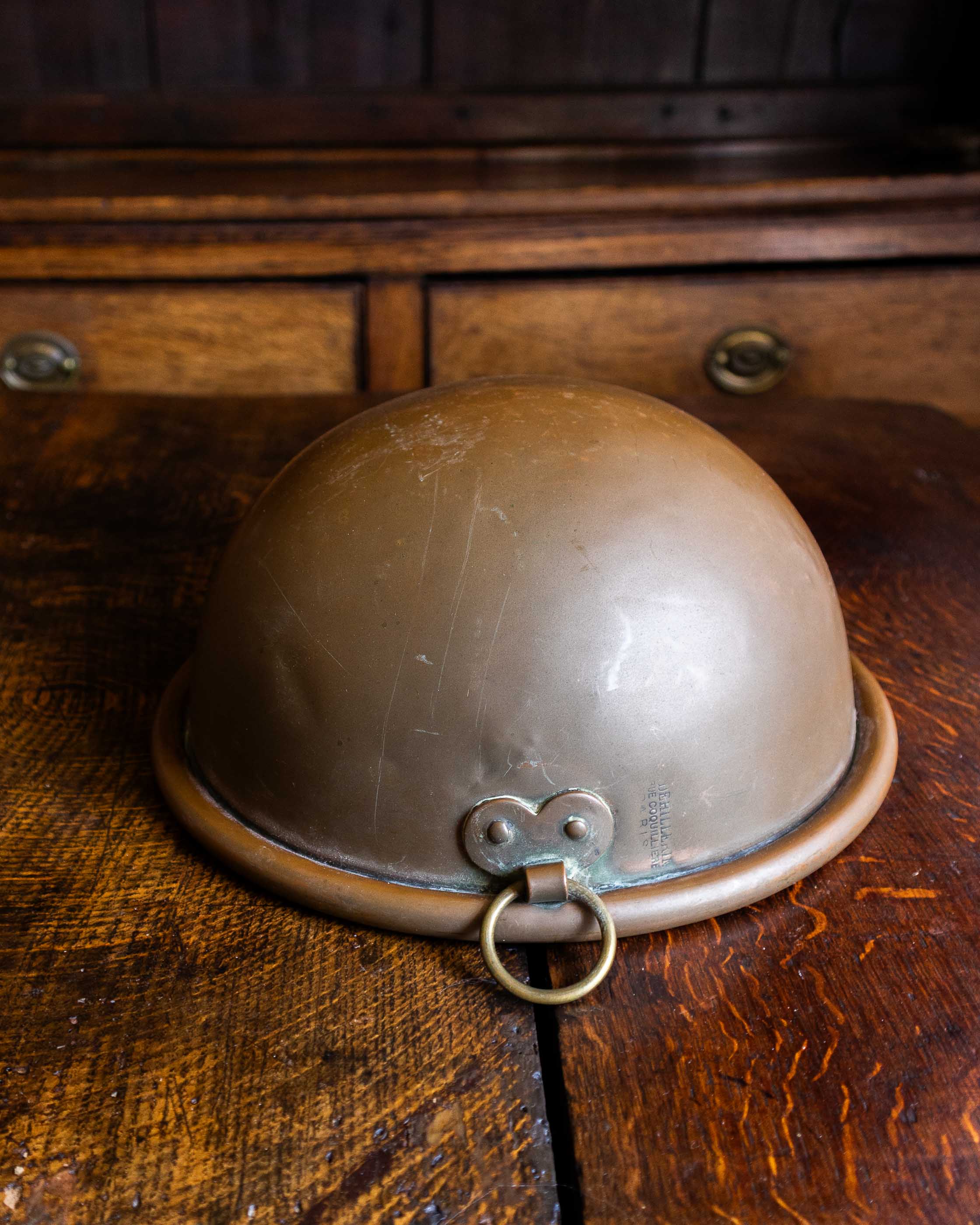 Copper bowl on a wooden surface