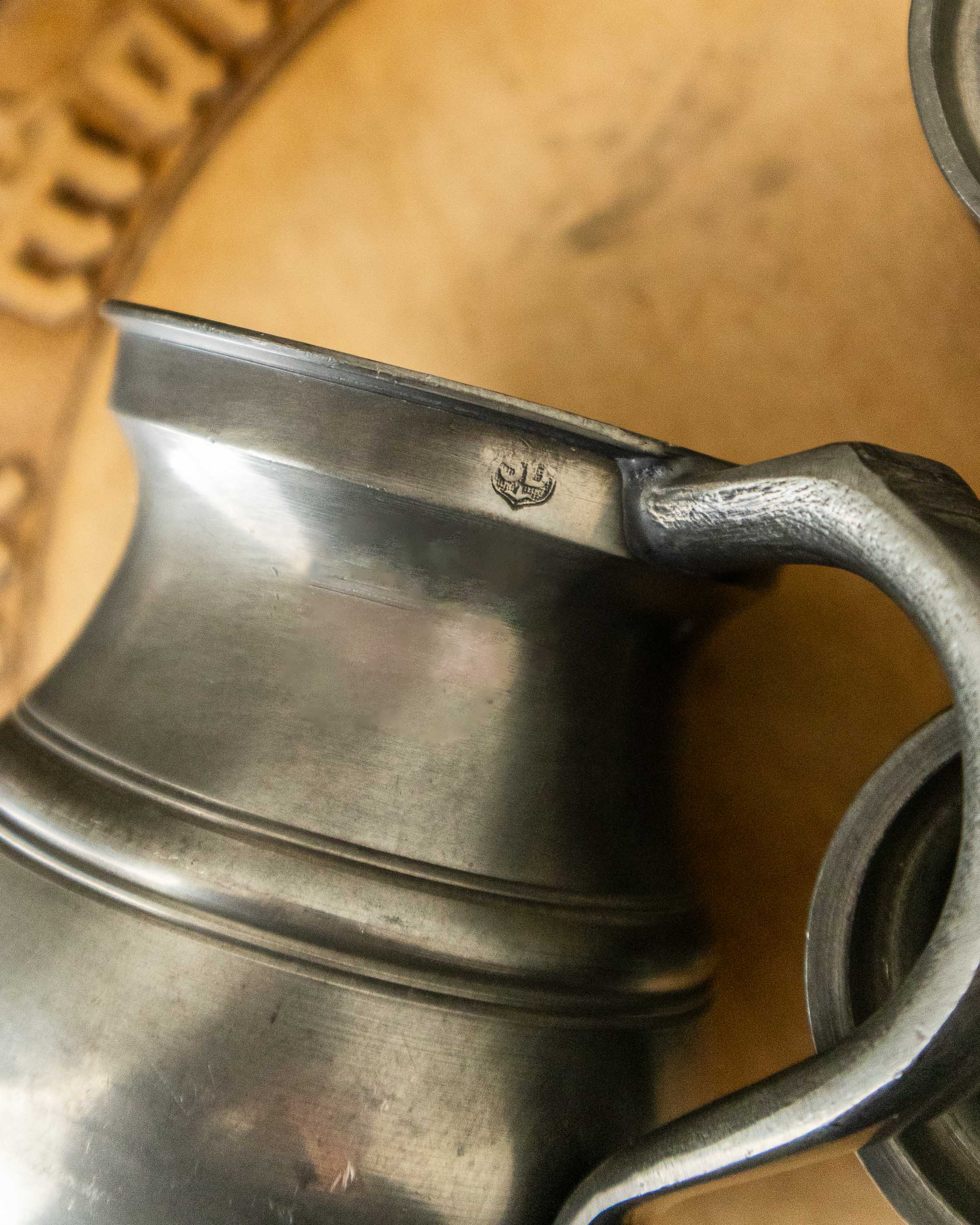 Close-up of a pewter measure with a blurred background