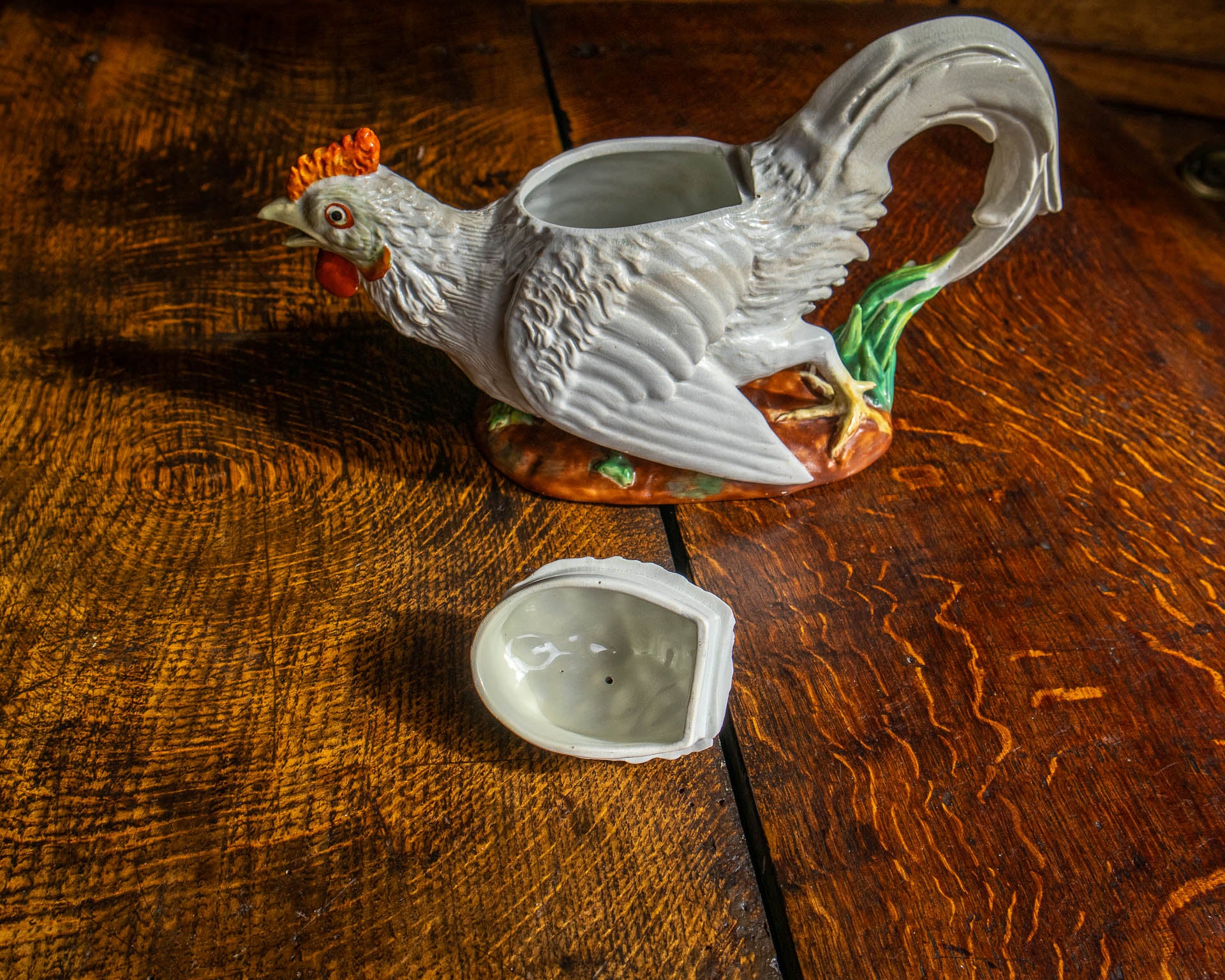 Decorative ceramic rooster teapot on a wooden surface