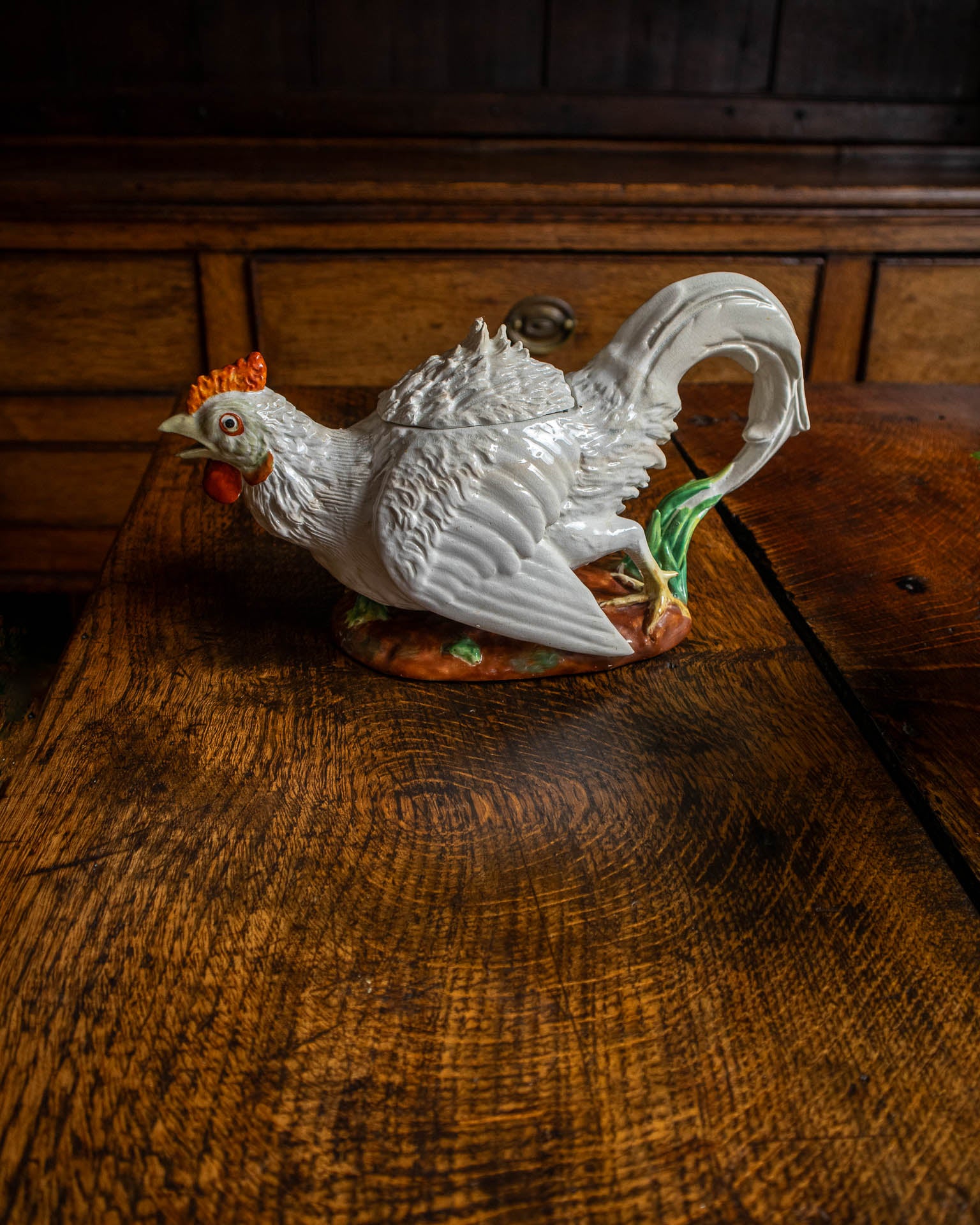 White ceramic rooster teapot on a wooden surface