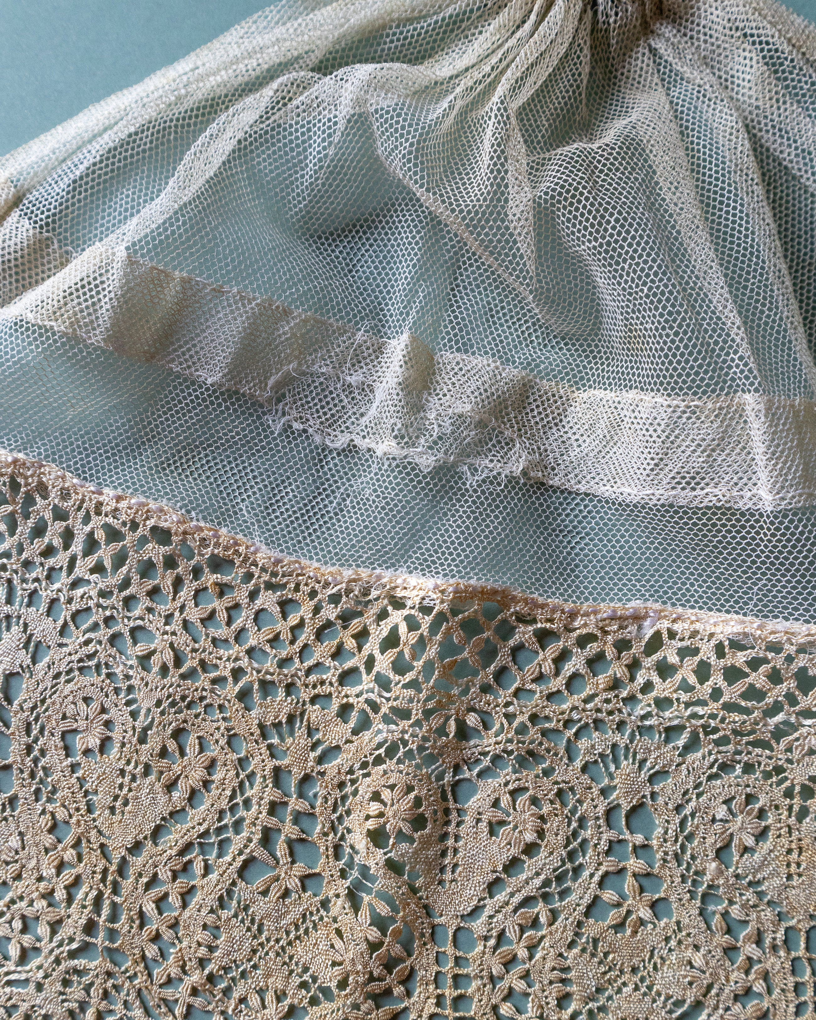 Close-up of lace with a textured edge on a light blue background