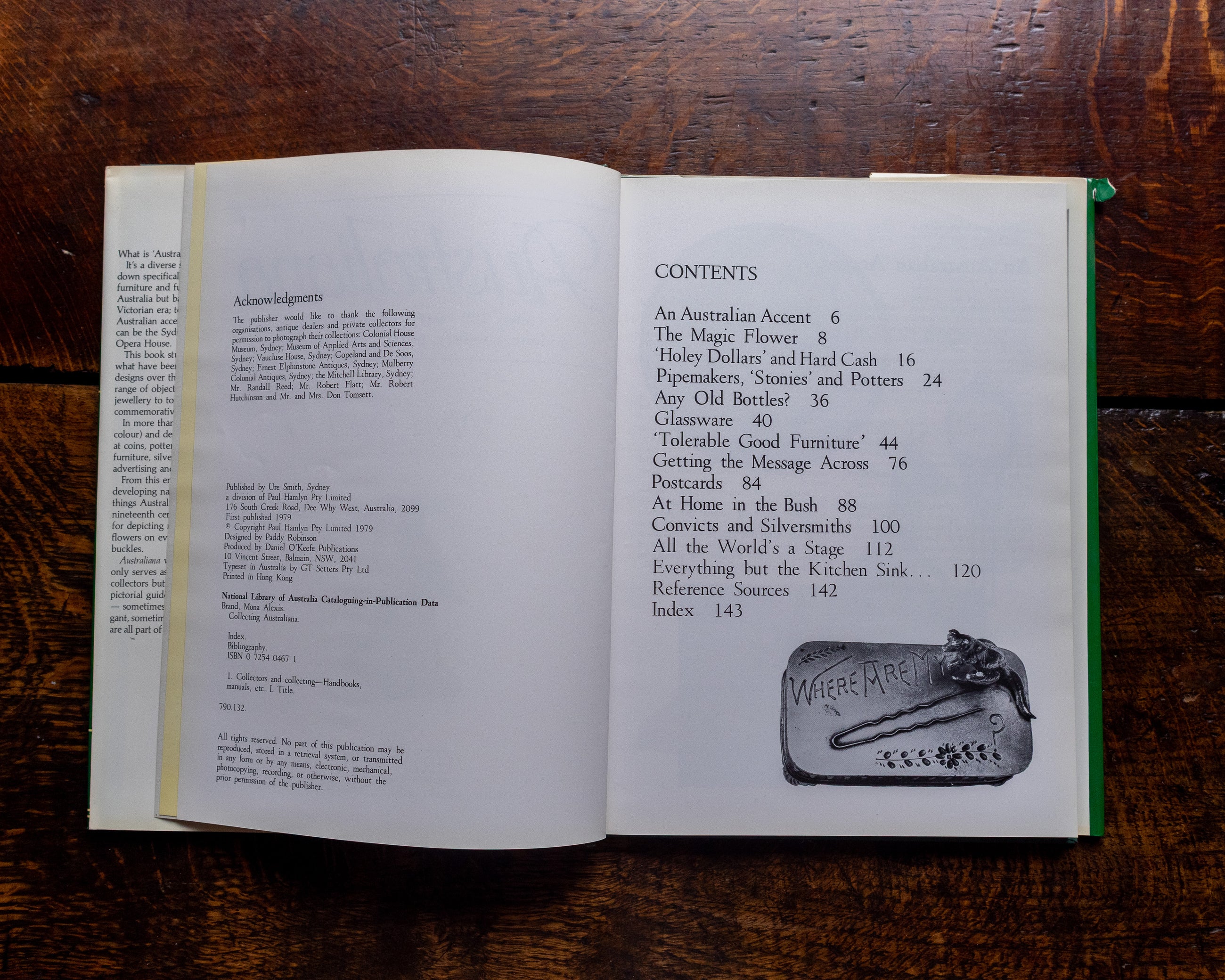Open book on a wooden surface with a small decorative item on top