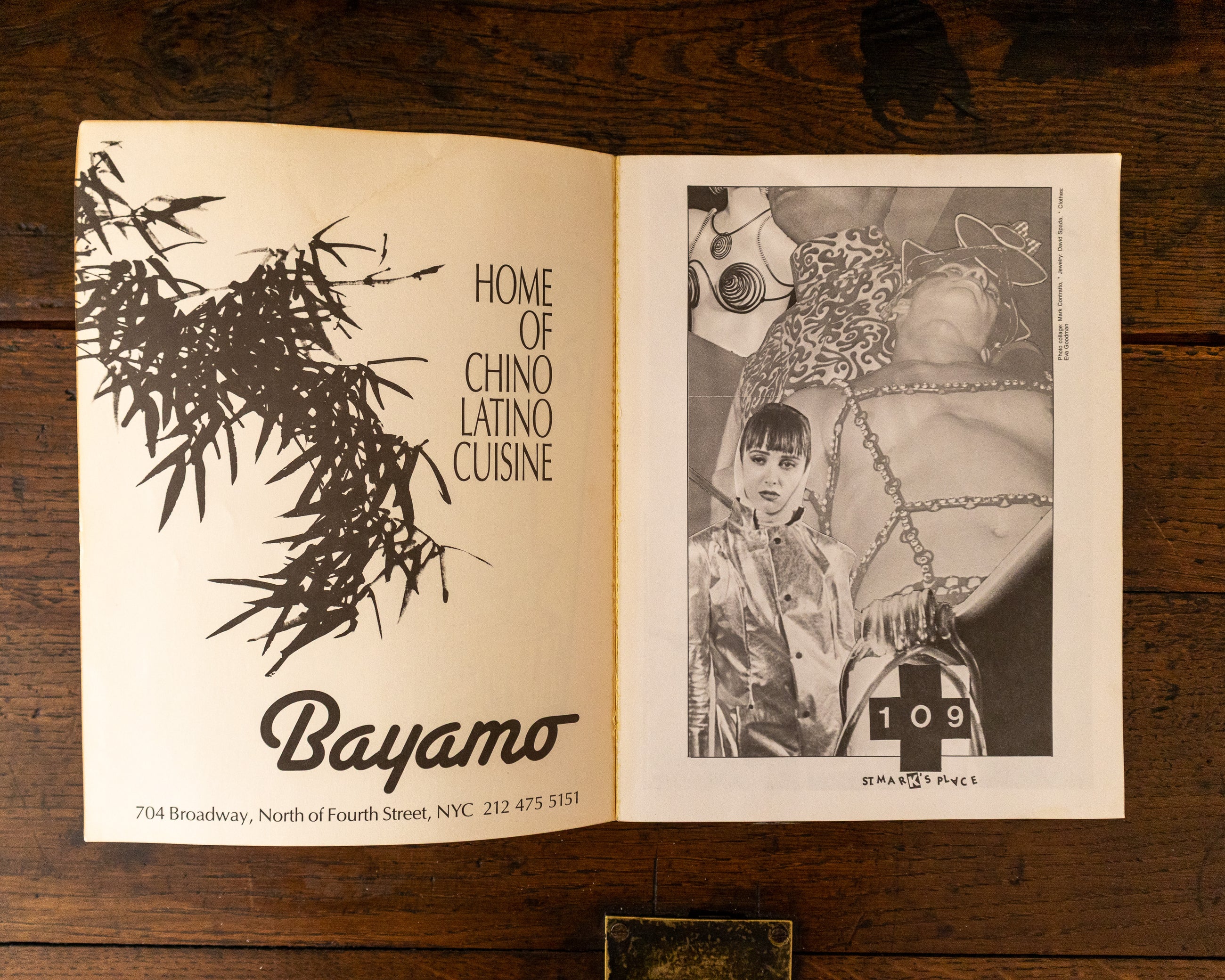 Open book with illustrations and text on a wooden surface