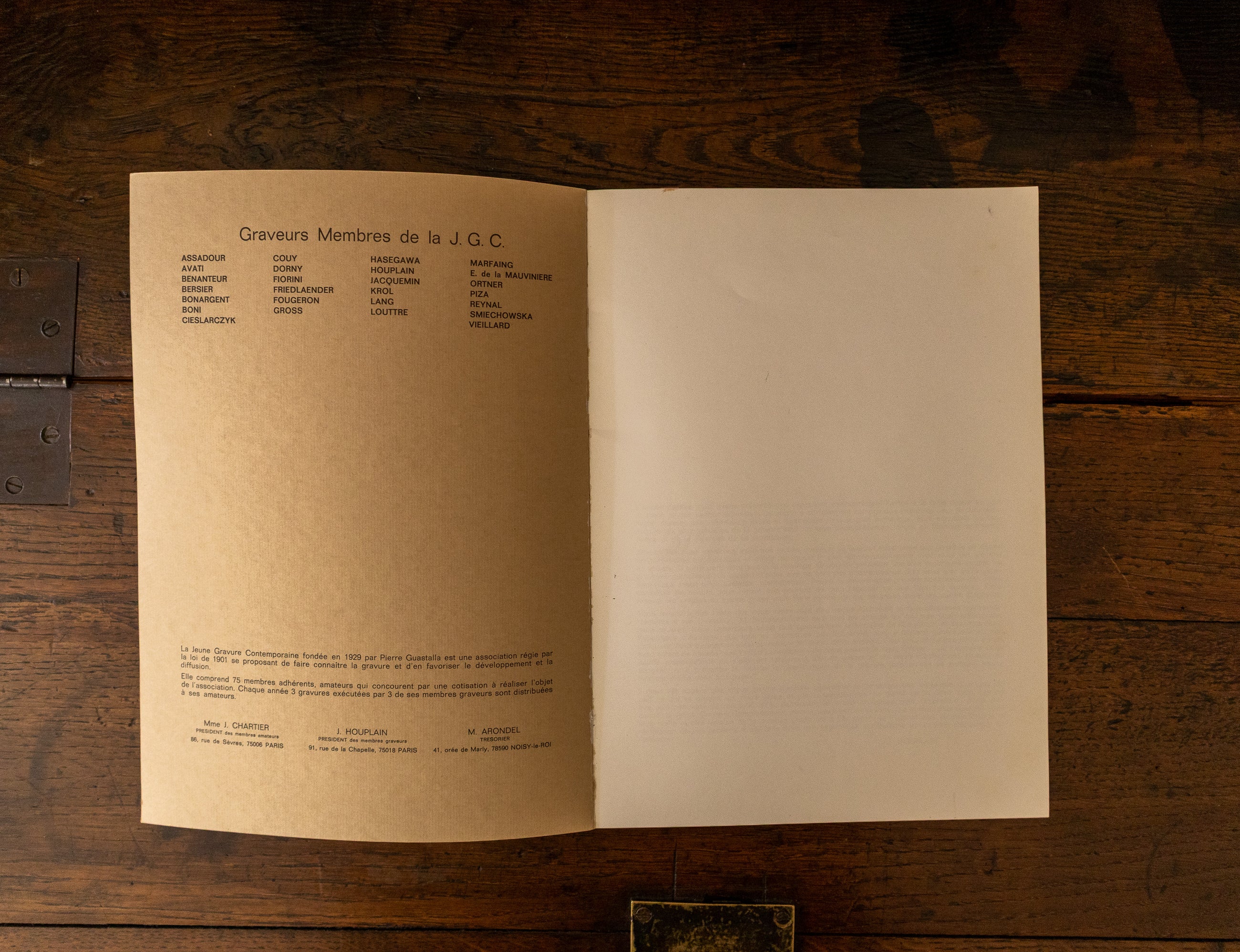 Open book on a wooden surface with text on the pages.