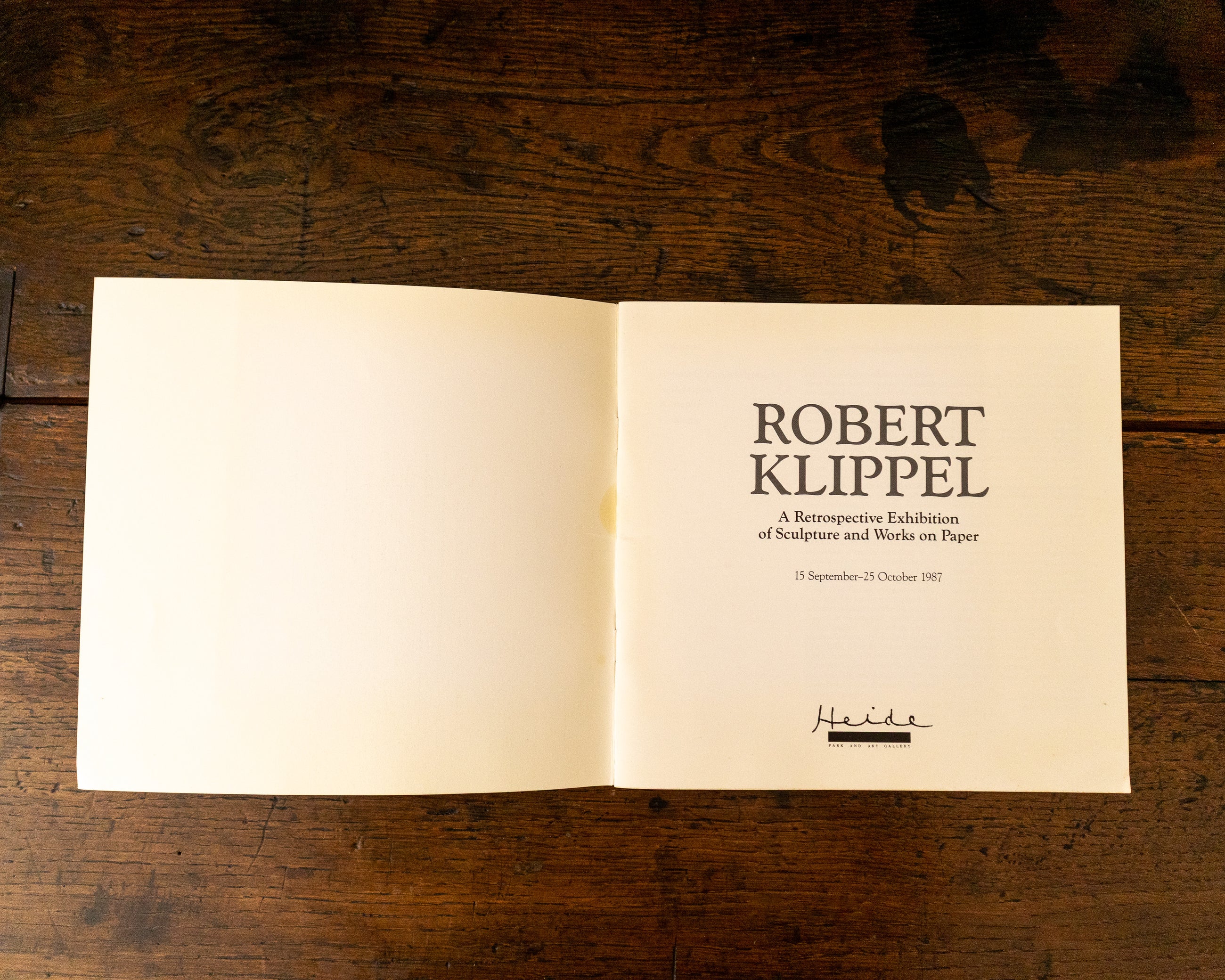 Open book with text on a wooden surface
