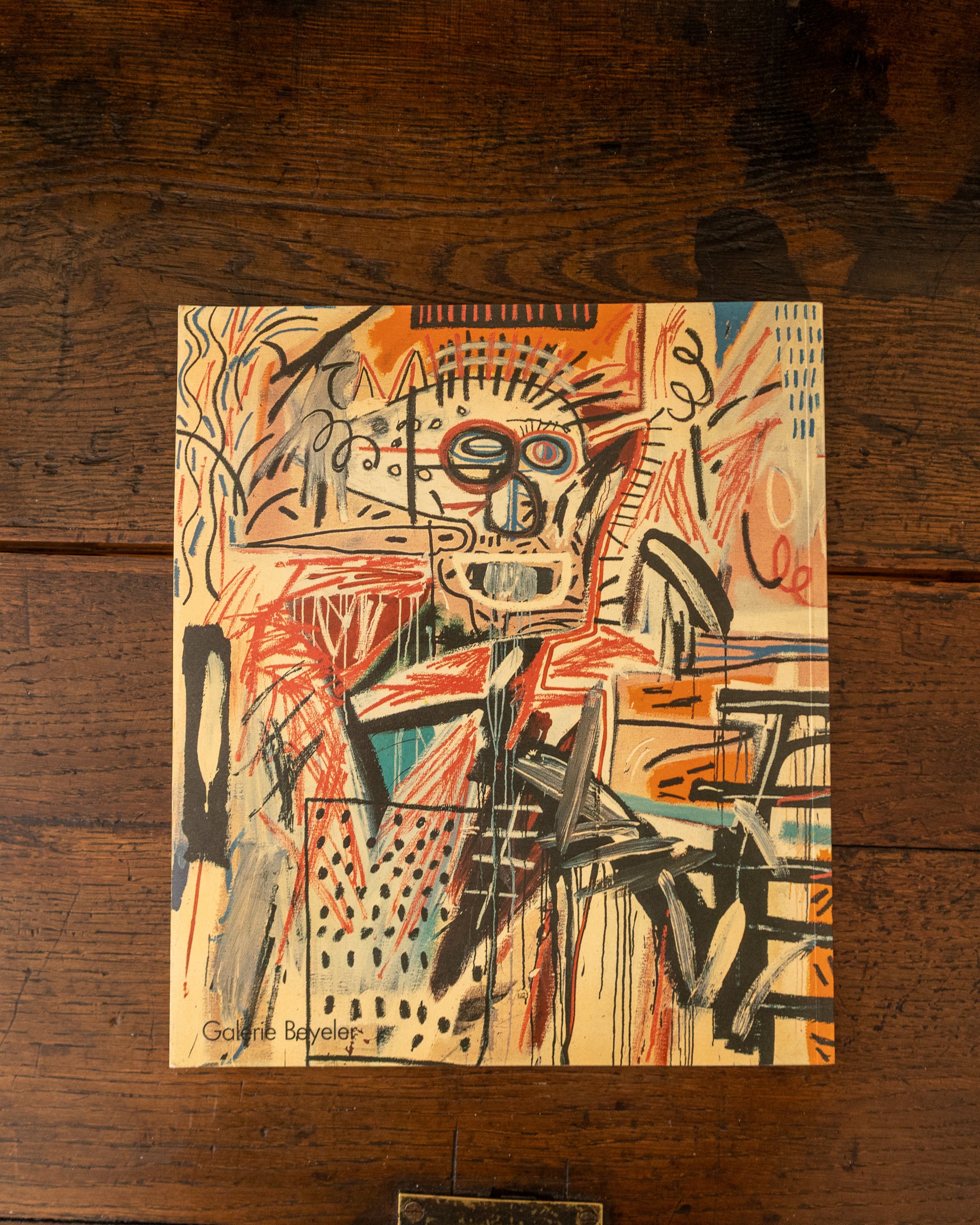 Back cover with abstract artwork on a wooden surface