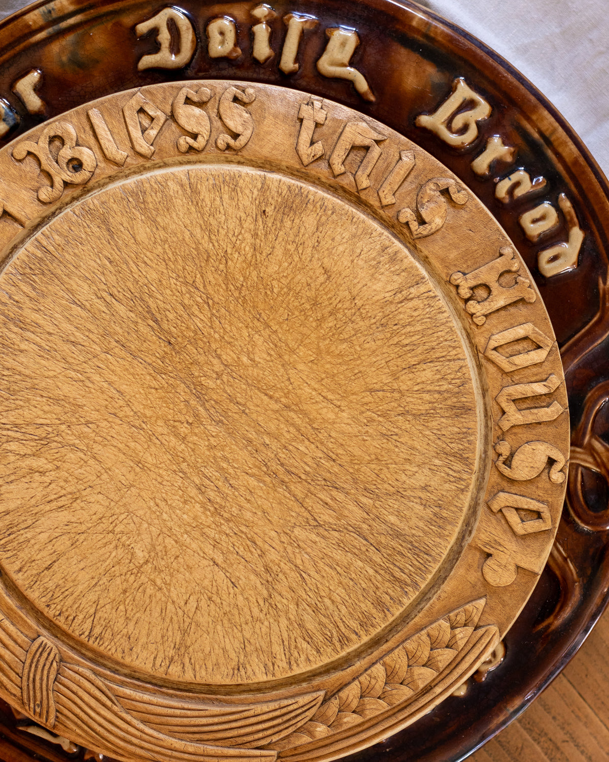 Antique breadboard with carved text and a circular design
