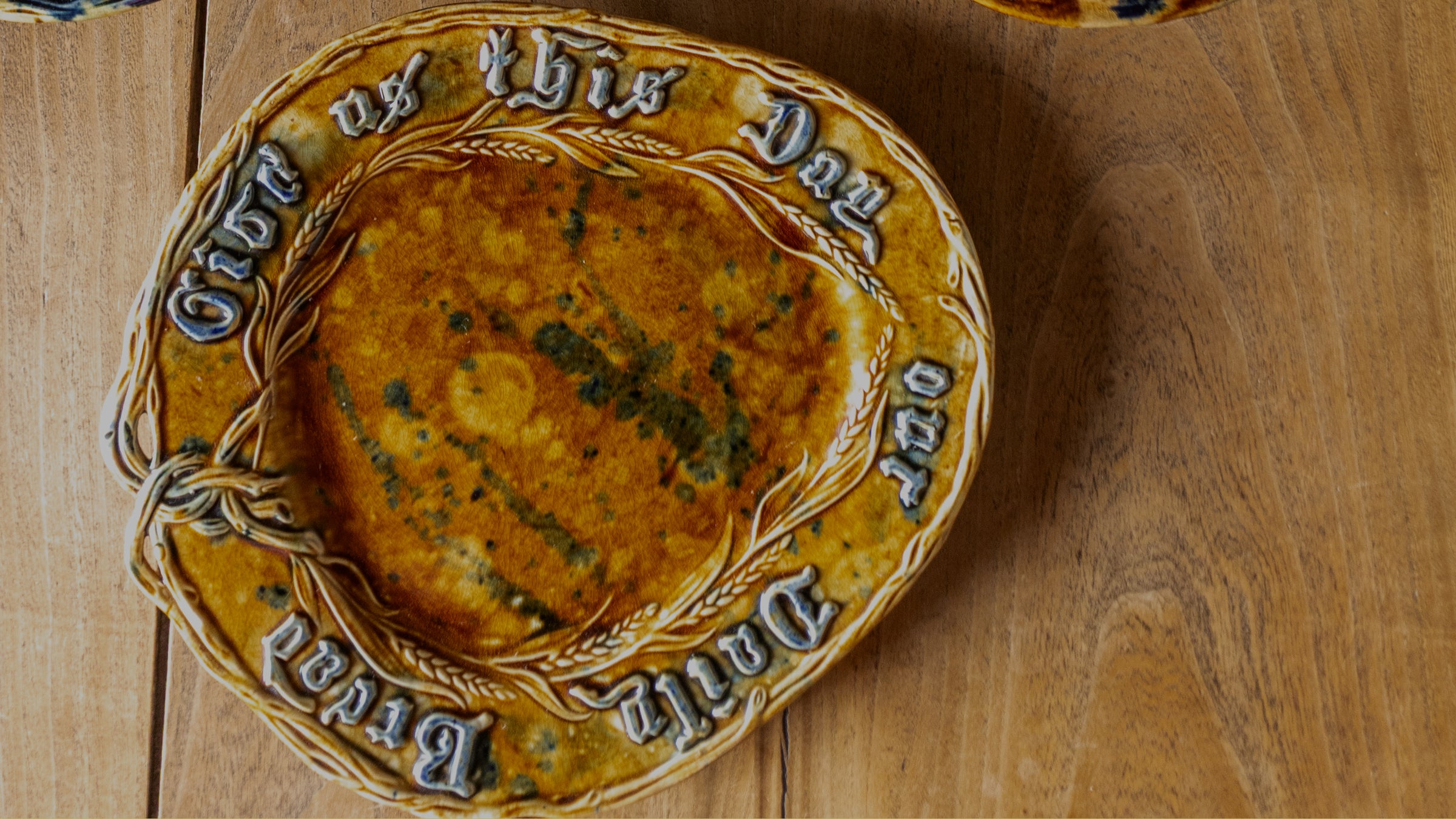 Ceramic plate with text on a wooden surface