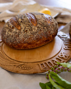 Loaf of bread on an antique wooden board with decorative carvings