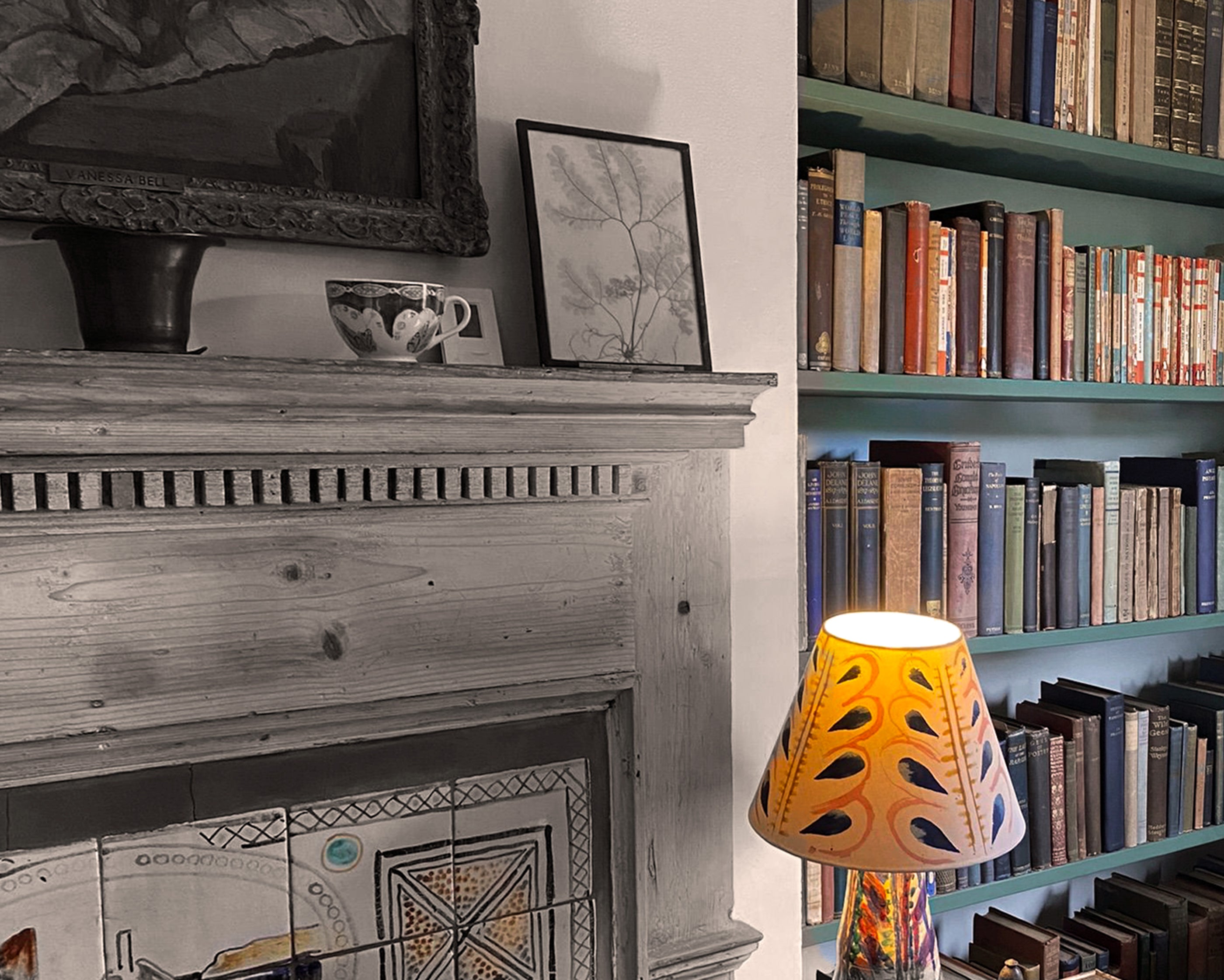 Bookshelf next to a fireplace with books and decorative items.