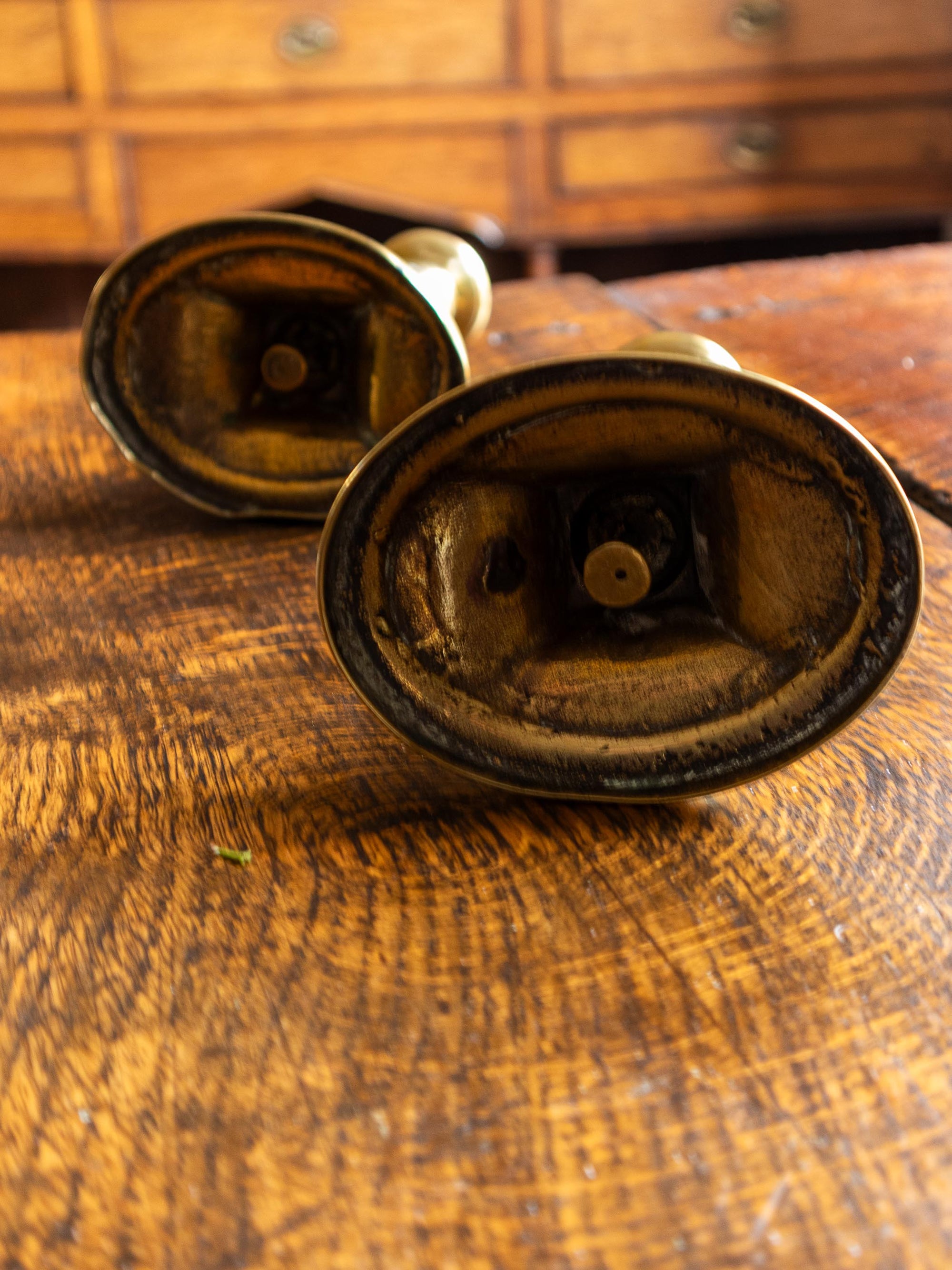 Pair of vintage brass candle holders on a wooden surface