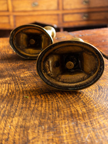 Pair of vintage brass candle holders on a wooden surface
