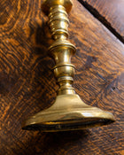 Brass candlestick on a wooden surface