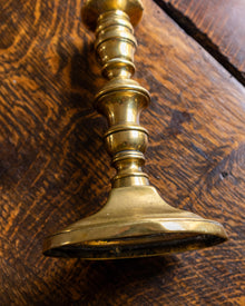 Brass candlestick on a wooden surface