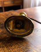 Brass candlestick on a wooden surface
