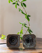 Brass tapersticks on a wooden surface