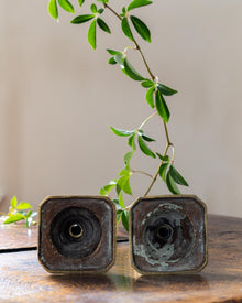 Brass tapersticks on a wooden surface