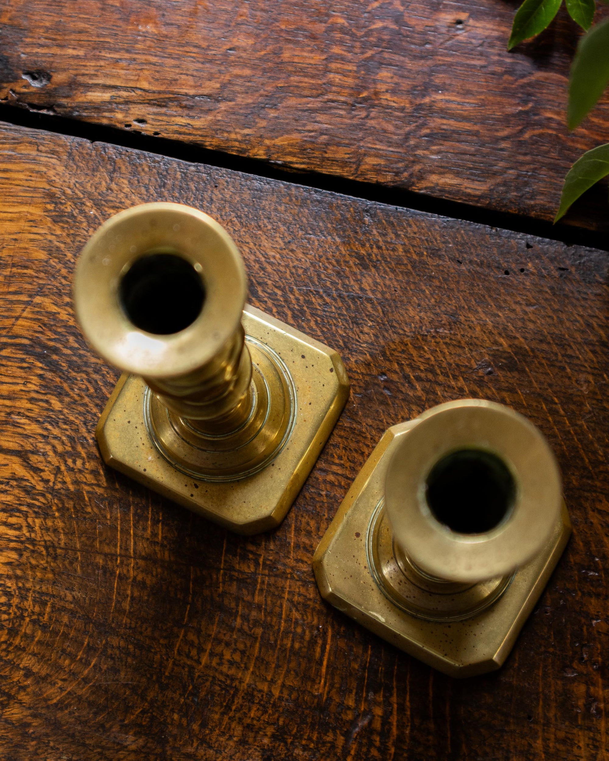Brass tapersticks on a wooden surface