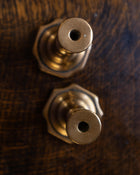 Brass tapersticks on a wooden surface