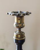 Decorative candle holder with intricate design on a beige background