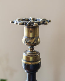 Decorative candle holder with intricate design on a beige background