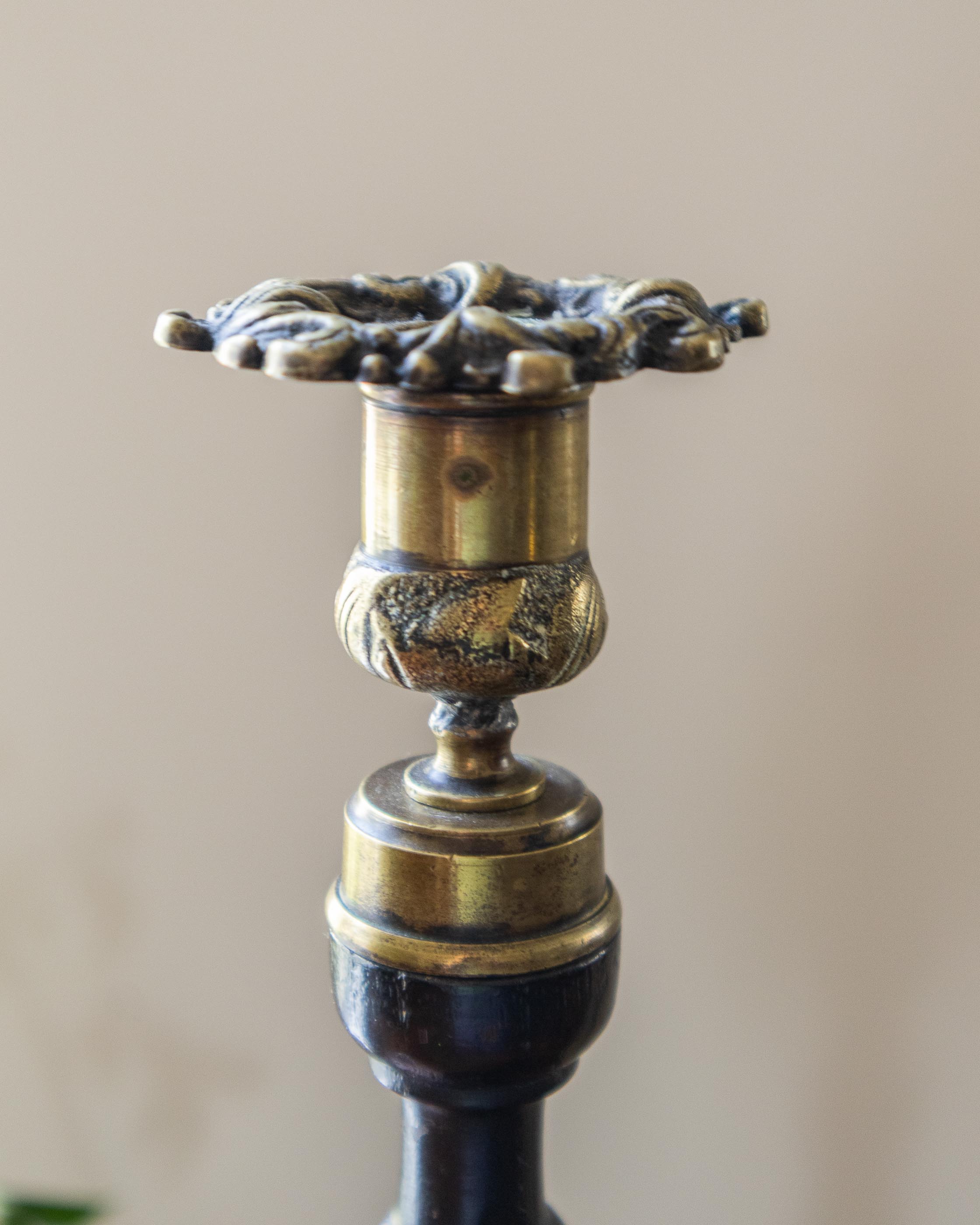 Decorative candle holder with intricate design on a beige background