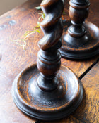 Wooden candlestick holders on a wooden surface